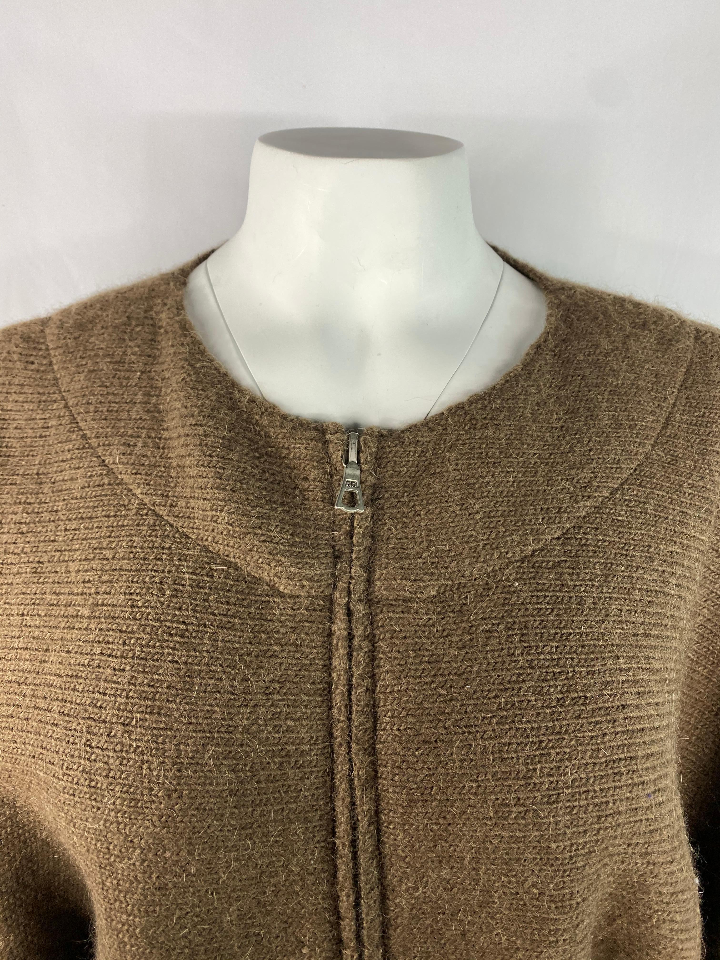 Product details:

Featuring brown, wool, knit sweater with crew neck line, silver tone front zip closure.