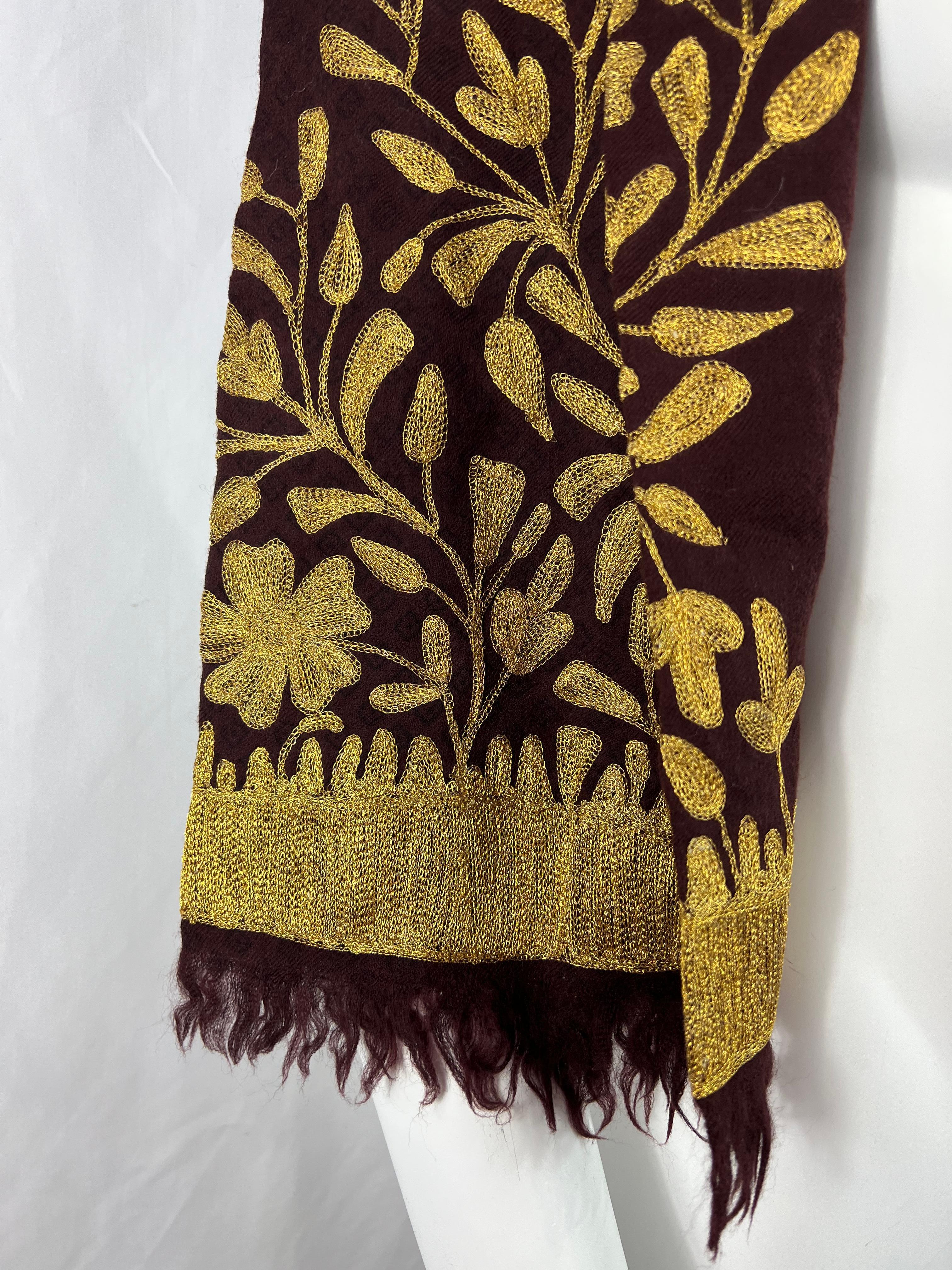 Product details:

The scarf features floral gold embroidery and fringe detail on the sides.