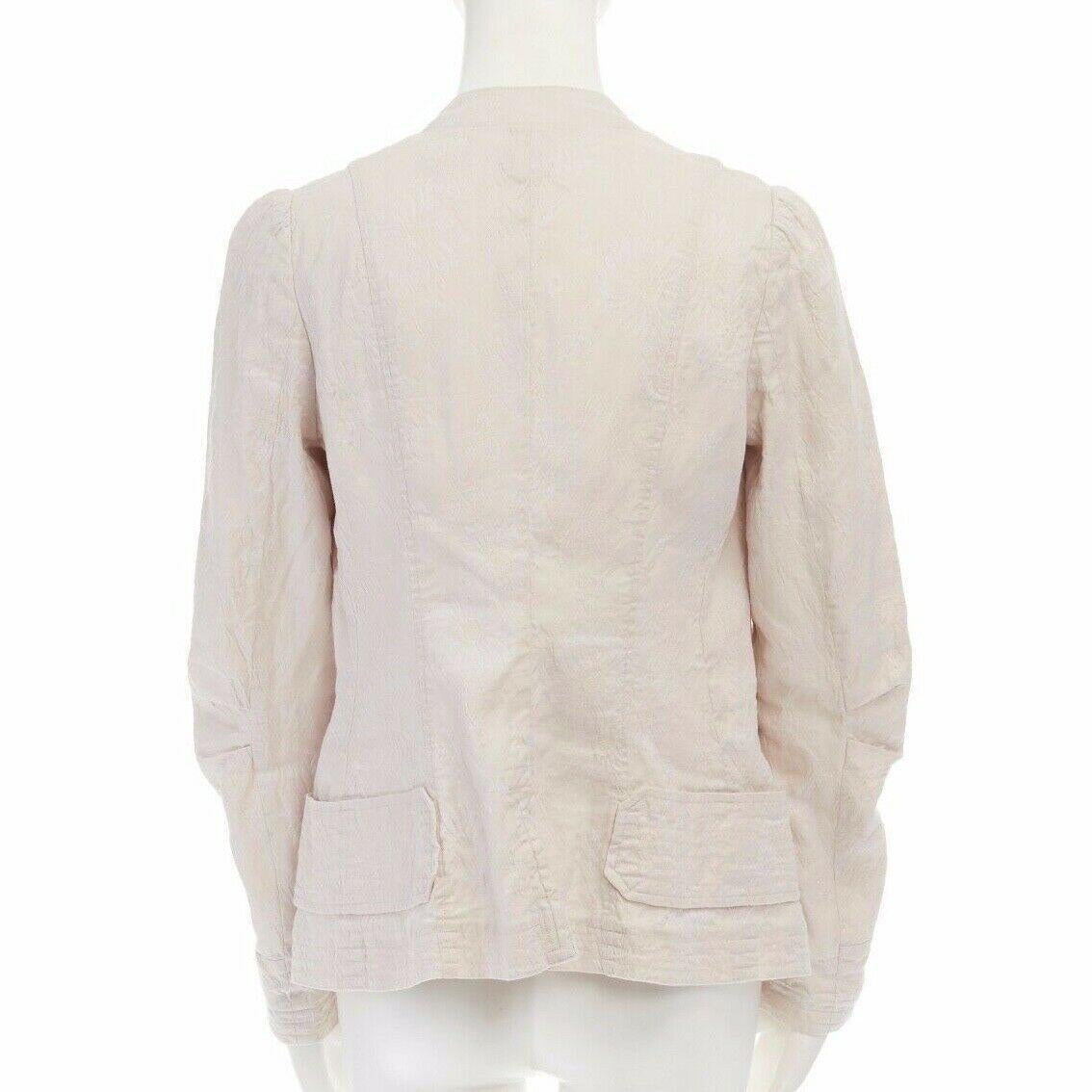 DRIES VAN NOTEN cream floral jacquard spread collar pleated sleeve jacket FR36 S

DRIES VAN NOTEN
Linen, cotton. Cream with white tonal floral jacquard. 
Stitched down spread collar. White collar lining. 
Mother of pearl button front closure.