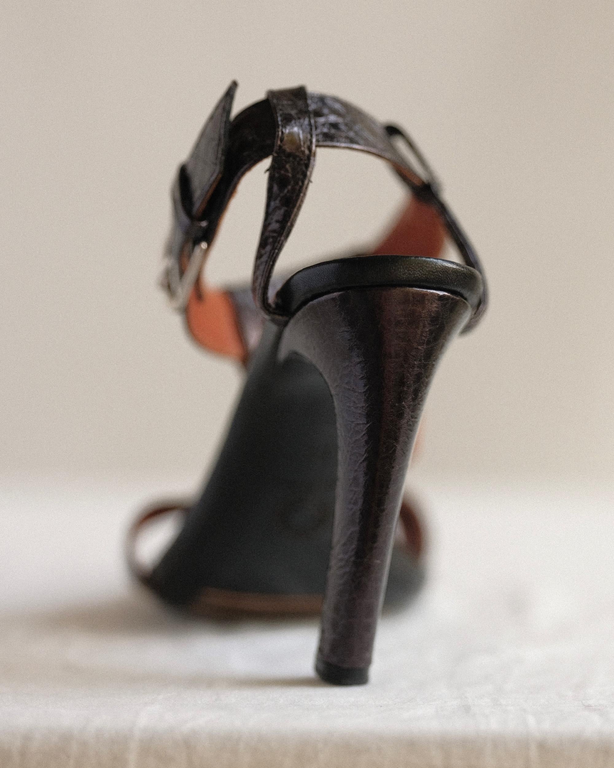 Dries Van Noten Embossed T-Strap Sandals
Black Leather
Tall Curved Heel, Wrapped in Embossed Leather
Wrap Around Straps & Buckle Closure at Ankles
Size: 37, Fits true
Heel height 4.5
Bottom shows wear, scuffs at soles, upper in great condition.