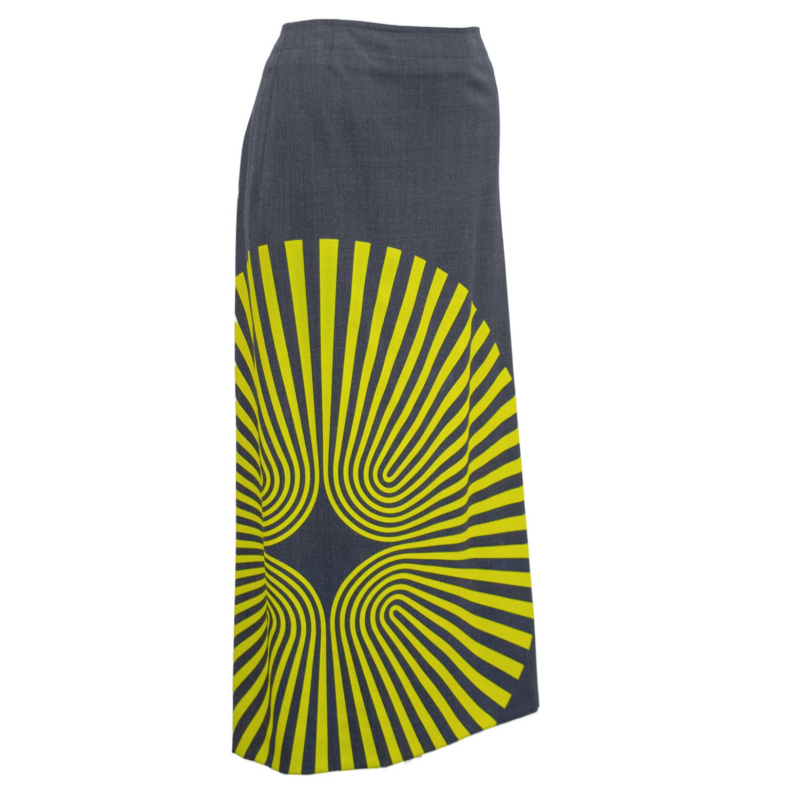 Grey wool Dries Van Noten Fall 2014 pencil skirt with overprinted yellow spiral pattern. Eye catching yet simple in its construction. Works well with any top. Exposed oversewn fastener with metal oversized zipper lines up with the left back hip, 
