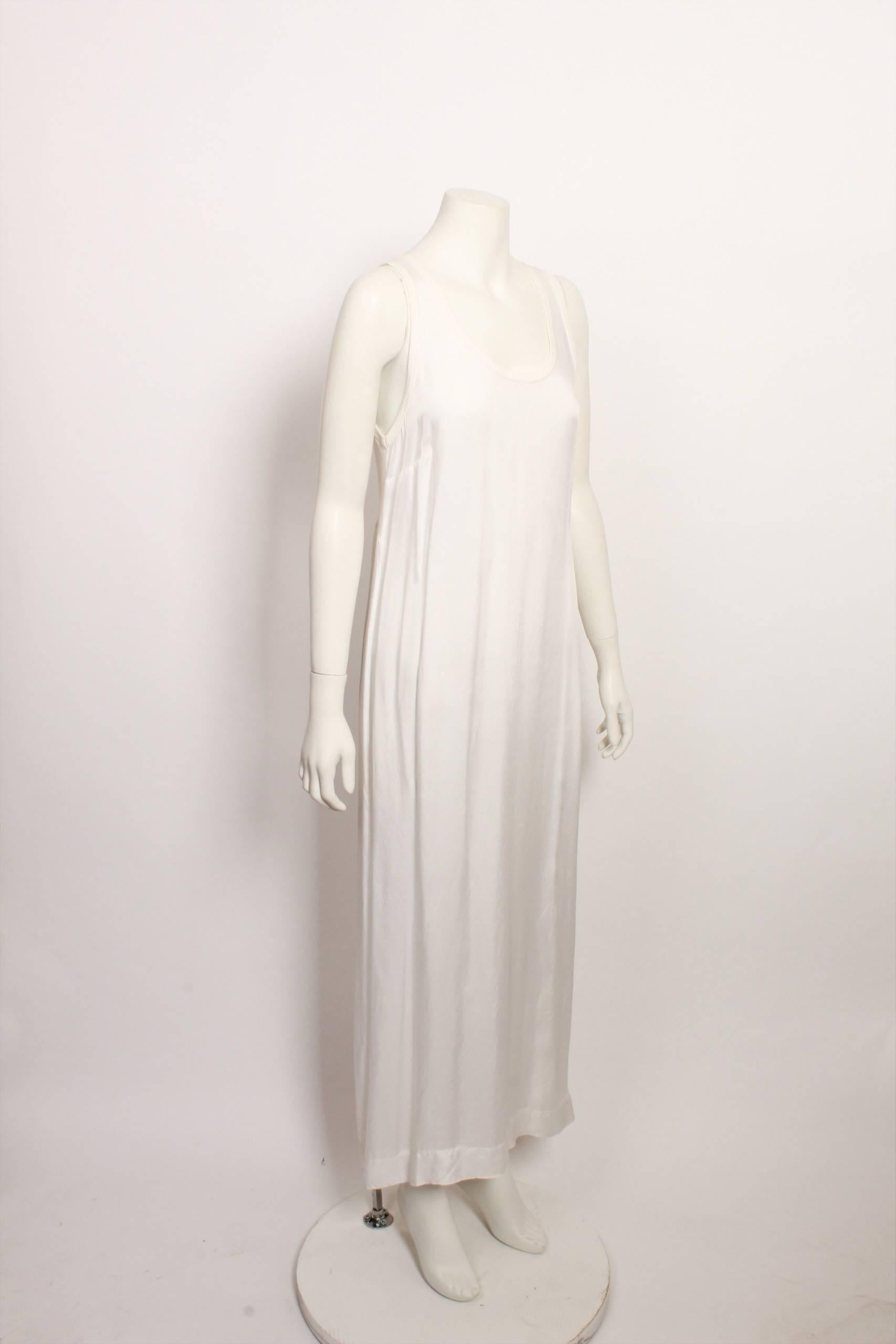 Full length white singlet slip style dress. Silky rayon main dress with ribbed cotton back bodice and neck and armhole rib. 
Back split at hem.
Size label has been removed but measures like medium. Can be worn as outer or under wear. 

