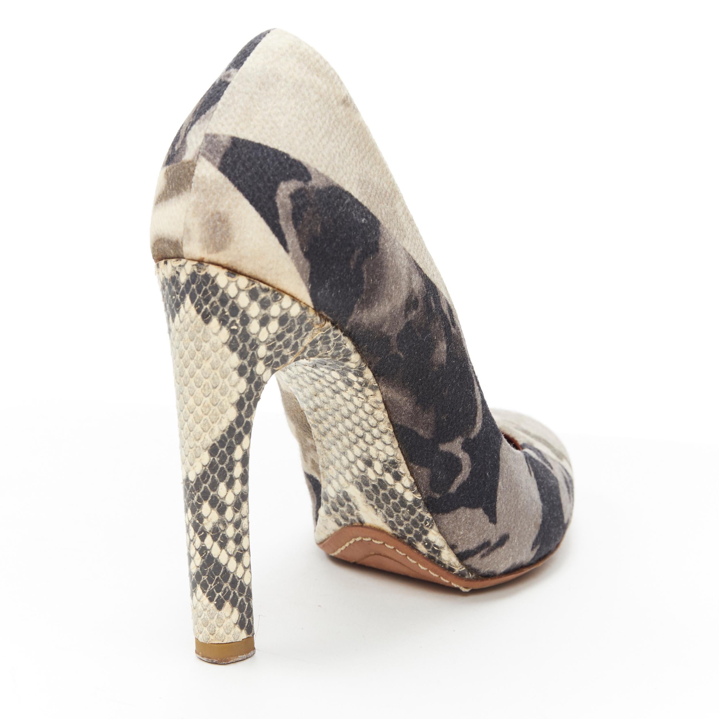 DRIES VAN NOTEN green camouflage print snake leather high heel pump EU36 
Reference: EACN/A00103 
Brand: Dries Van Noten 
Designer: Dries Van Noten 
Material: Fabric 
Color: Grey 
Pattern: Camouflage 
Extra Detail: Grey camouflage print upper.