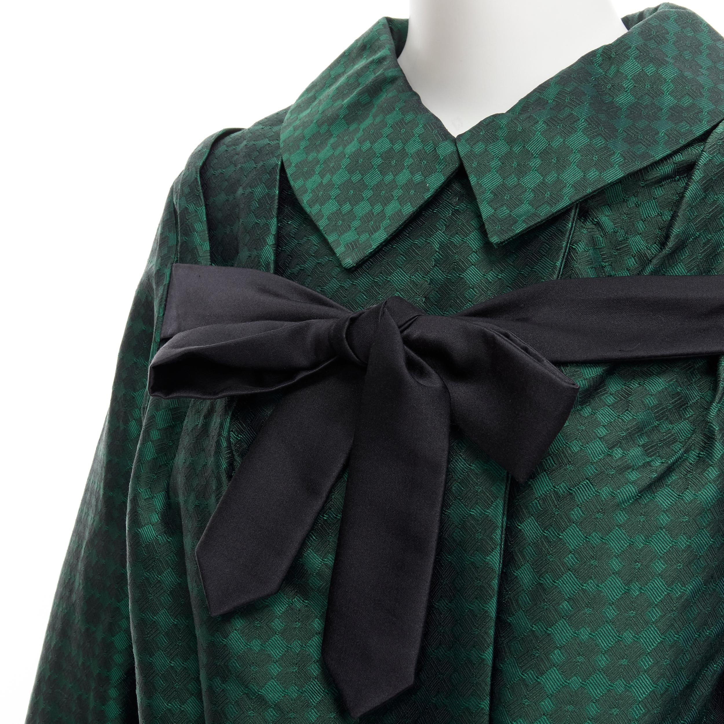 DRIES VAN NOTEN green geometric jacquard black silk bow belted opera coat S 
Reference: CELG/A00154 
Brand: Dries Van Noten 
Designer: Dries Van Noten 
Color: Green 
Pattern: Geometric 
Closure: Button 
Extra Detail: Attached silk sash attached at