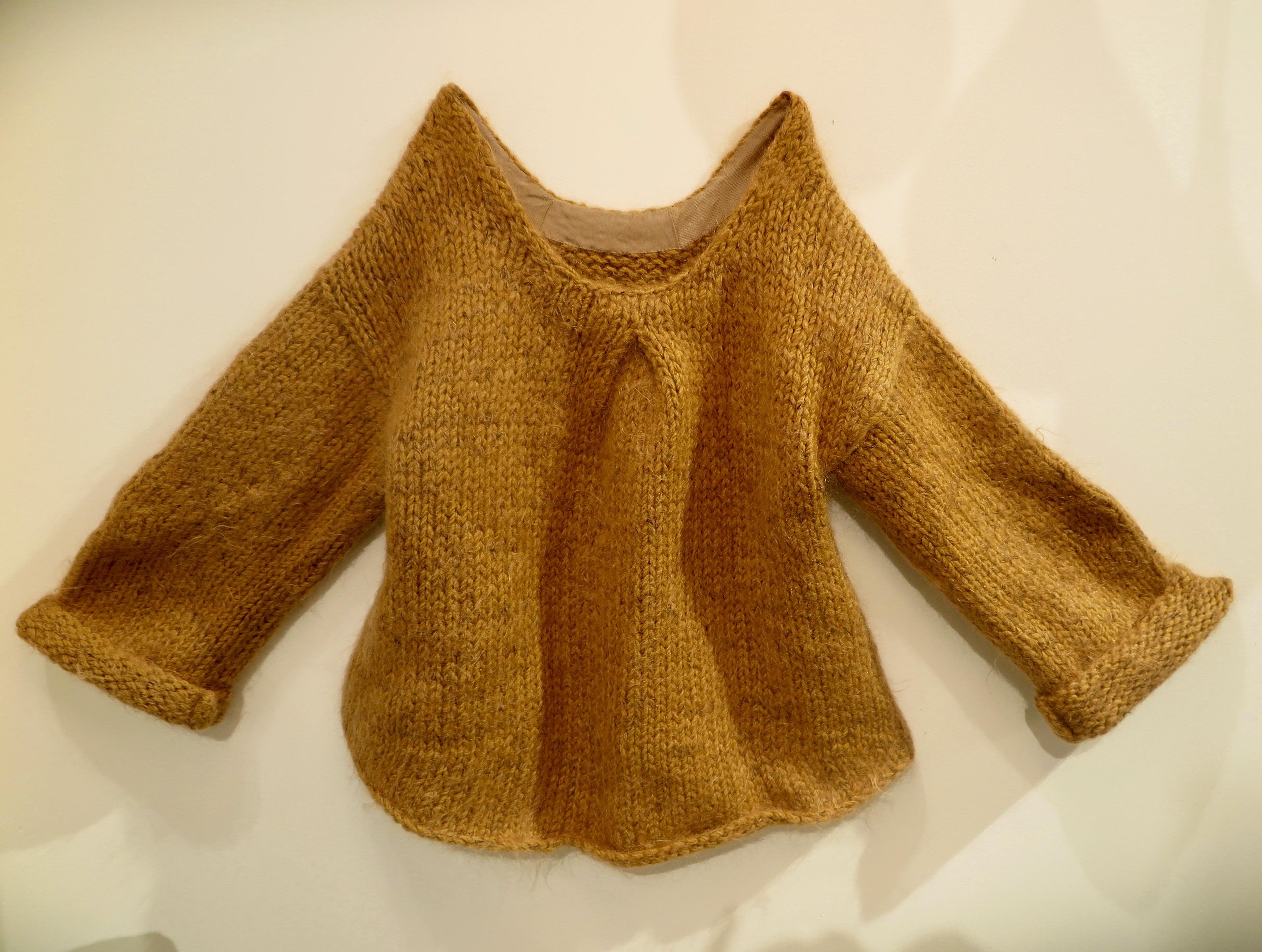 Hand knit sweater in mohair in salmon color with shorter height in front and longer in back by Dries Van Noten.