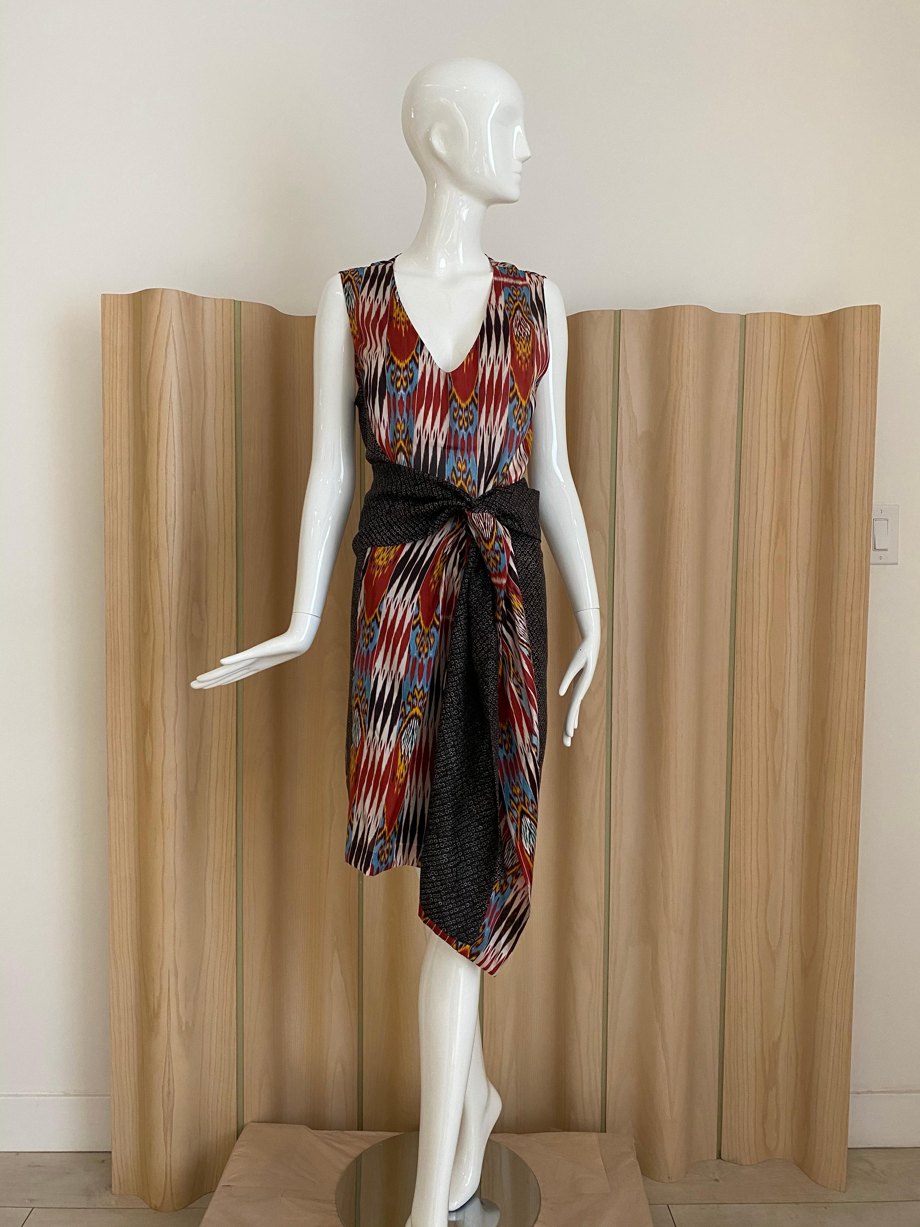 Dries Van Noten Ikat print sleeveless Silk Dress in maroon, blue, white, and orange.
Marked: 42 . 
Bust: 42” / Hip: 42”