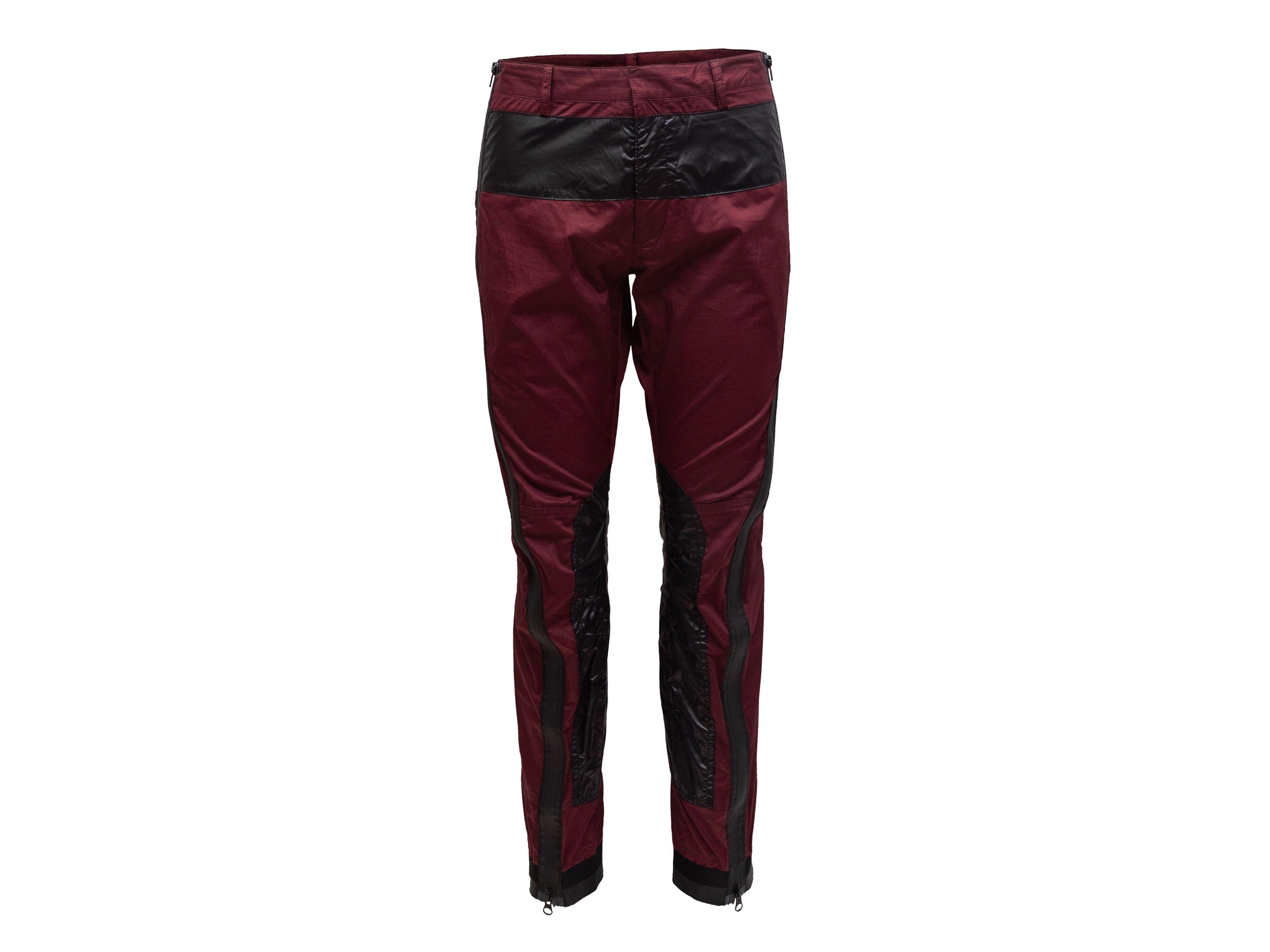 Product Details: Maroon and black color block skinny-leg pants by Dries Van Noten. Dual back pockets. Zip accents at sides. Zip closure at front. Designer size 48. 32