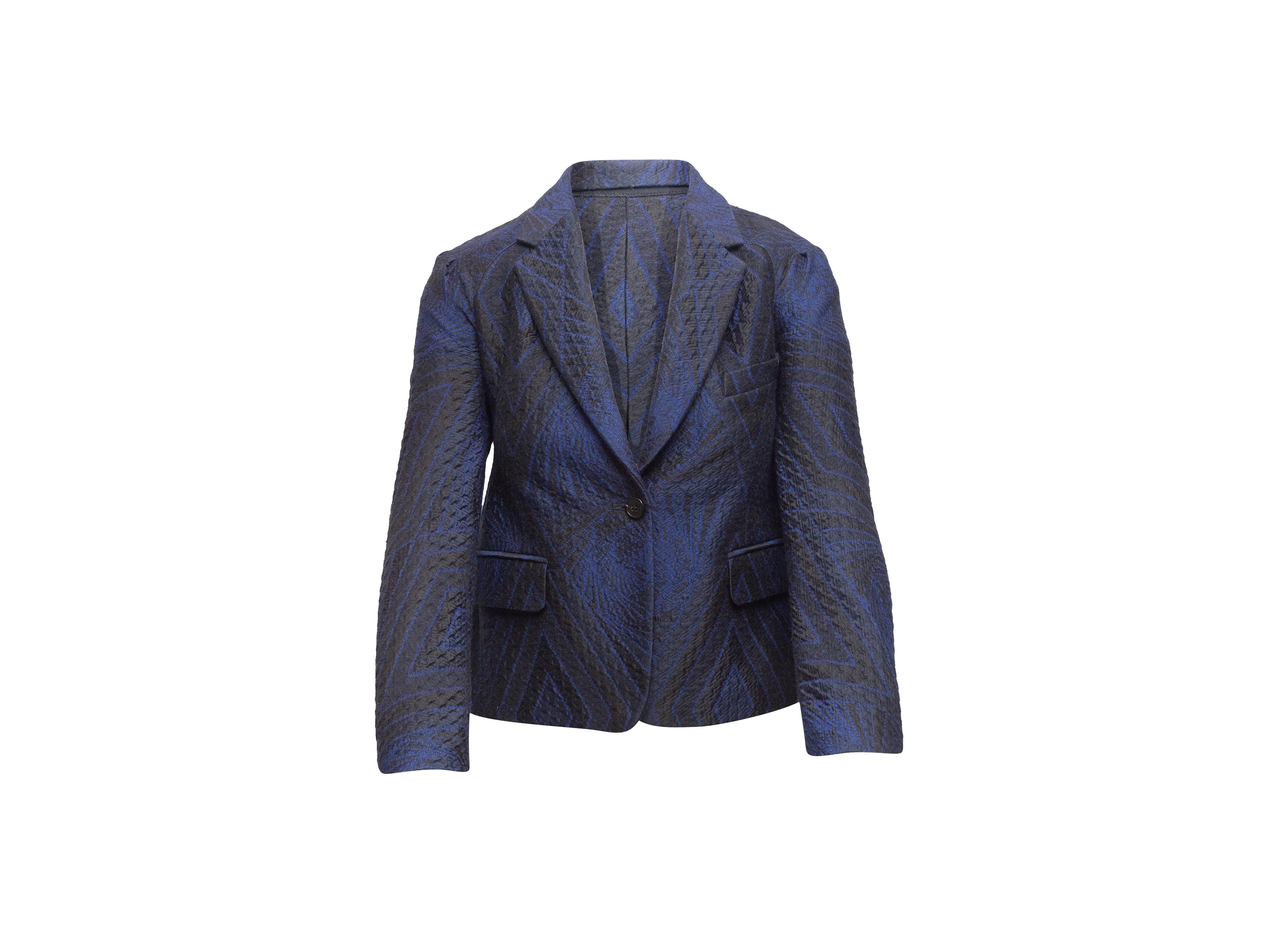 Product details: Navy and black jacquard patterned blazer by Dries Van Noten. Notched lapel. Single welt pocket at bust. Dual flap pockets at hips. Button closure at front. Designer size 38. 31