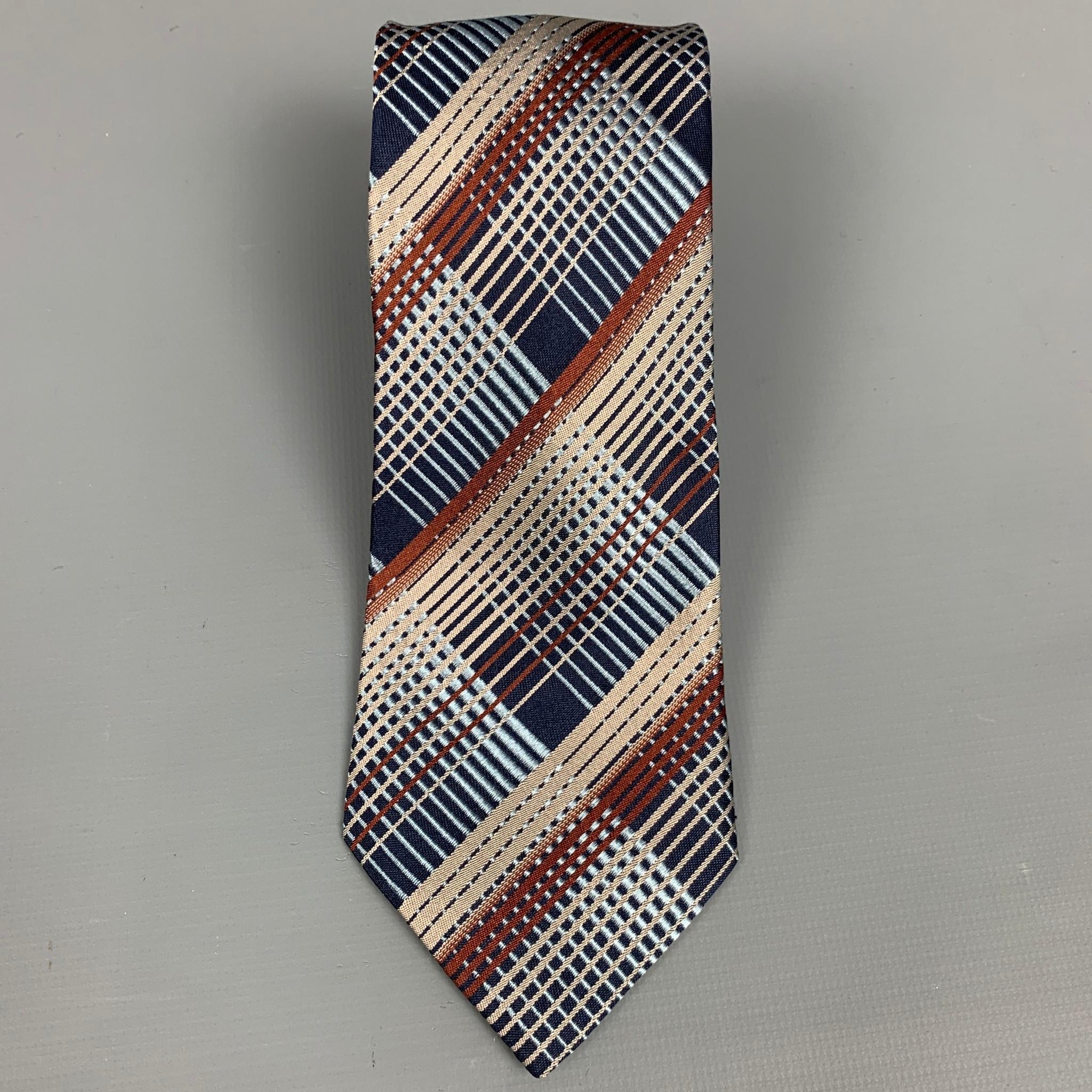 DRIES VAN NOTEN neck tie comes in a navy & brown plaid silk. Made in Italy.

Very Good Pre-Owned Condition.

Width: 3.5 in.  