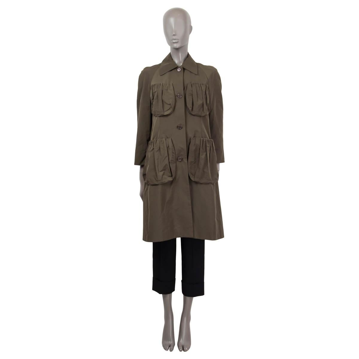 100% authentic Dries van Noten 'Shell' coat in green polyester (58%) and cotton (42%). Features four patch pockets on the front and 3/4 raglan sleeves (sleeve measurements taken from the neck). Opens with buttons on the front. Lined in green viscose