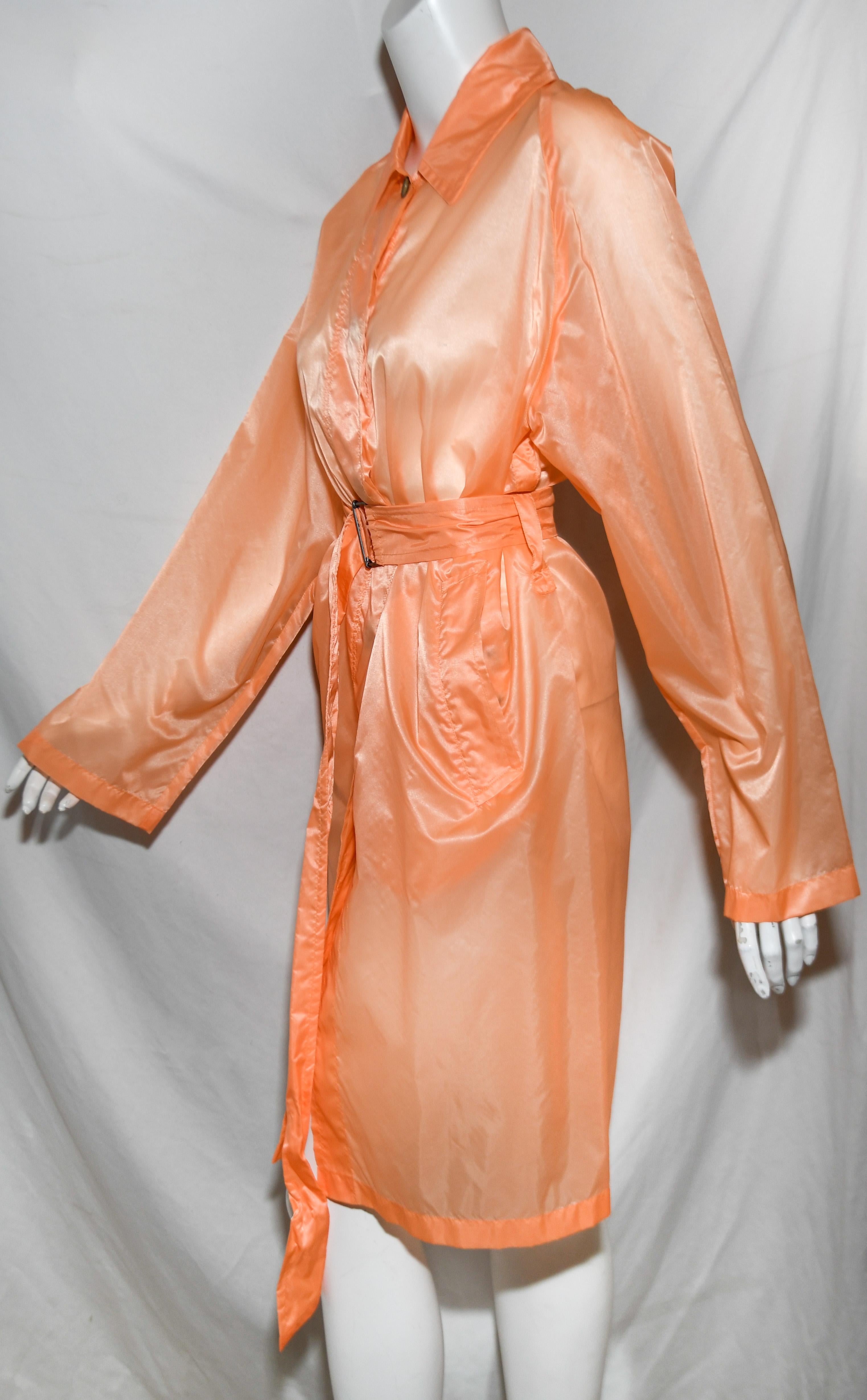 Dries van Noten orange light weight semi sheer raincoat includes a belt like sash.   This raincoat contains 2 front patch pockets and 5 buttons at front for closure.  This coat is in excellent condition.  Made in Romania