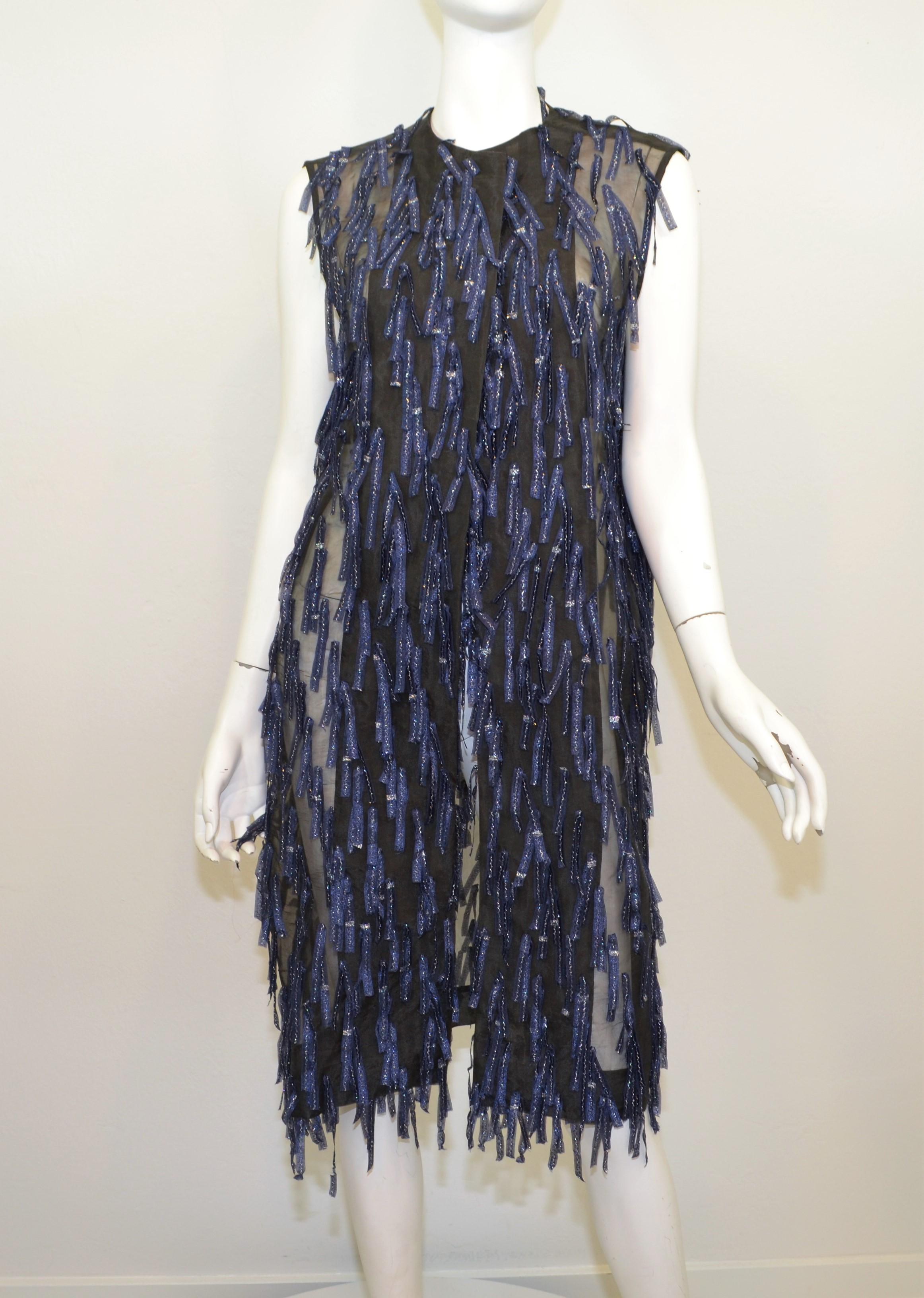 Dries Van Noten sleeveless coat is featured in a black organza fabric with navy blue and silver fringed applique allover. Coat has an open front and is labeled a size 40, made in Belgium. 

Measurements:
Bust - 42''
Length - 40''