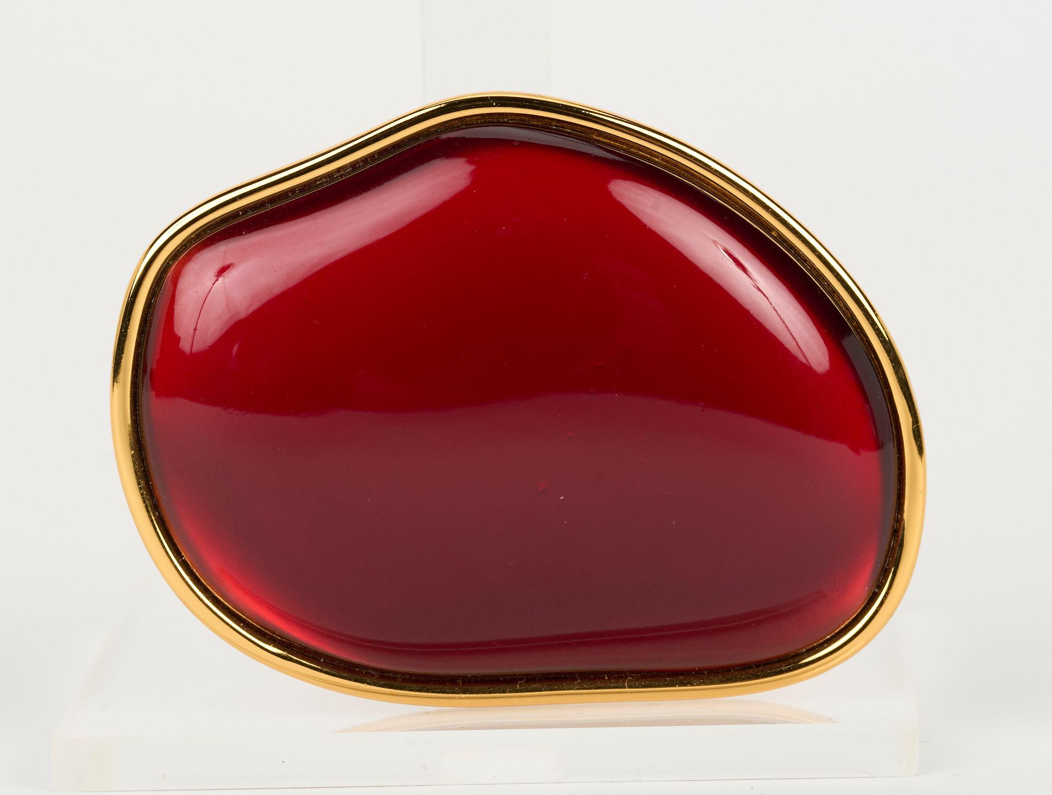 Dries Van Noten oversize costume jewelry ring, yellow gold plating metal and red lucite cabochon. Size 6 1/4. Comes with original box.