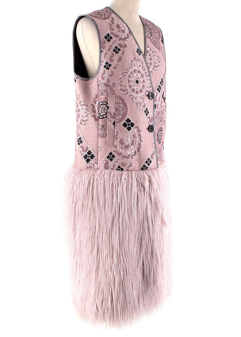 Dries Van Noten Pink Brocade Jacquard Gilet with Faux-Shearling Hem

- Richly decorated pink brocade jacquard body, contrasted with a faux-shearling hemline
- Faux-shearling in the style of Mongolian lamb, featuring a long curly pile
- Collarless, 2