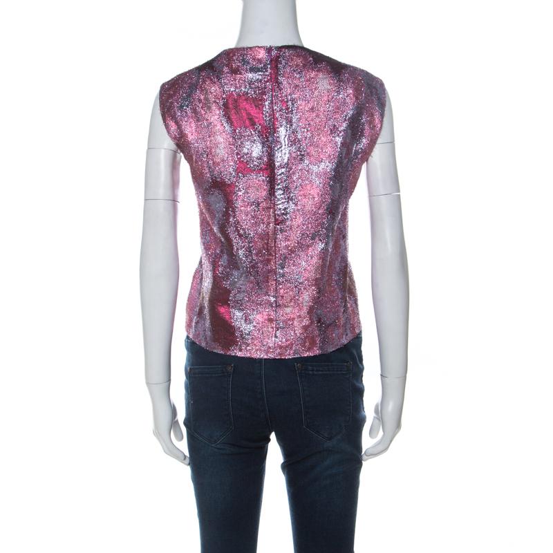 This pink top from the house of Dries van Noten has been made to suit a diverse range of outfits. It has a jacquard design which glints when it catches the light. The top is dressy and can be paired with a pair of dark denims to deliver a chic