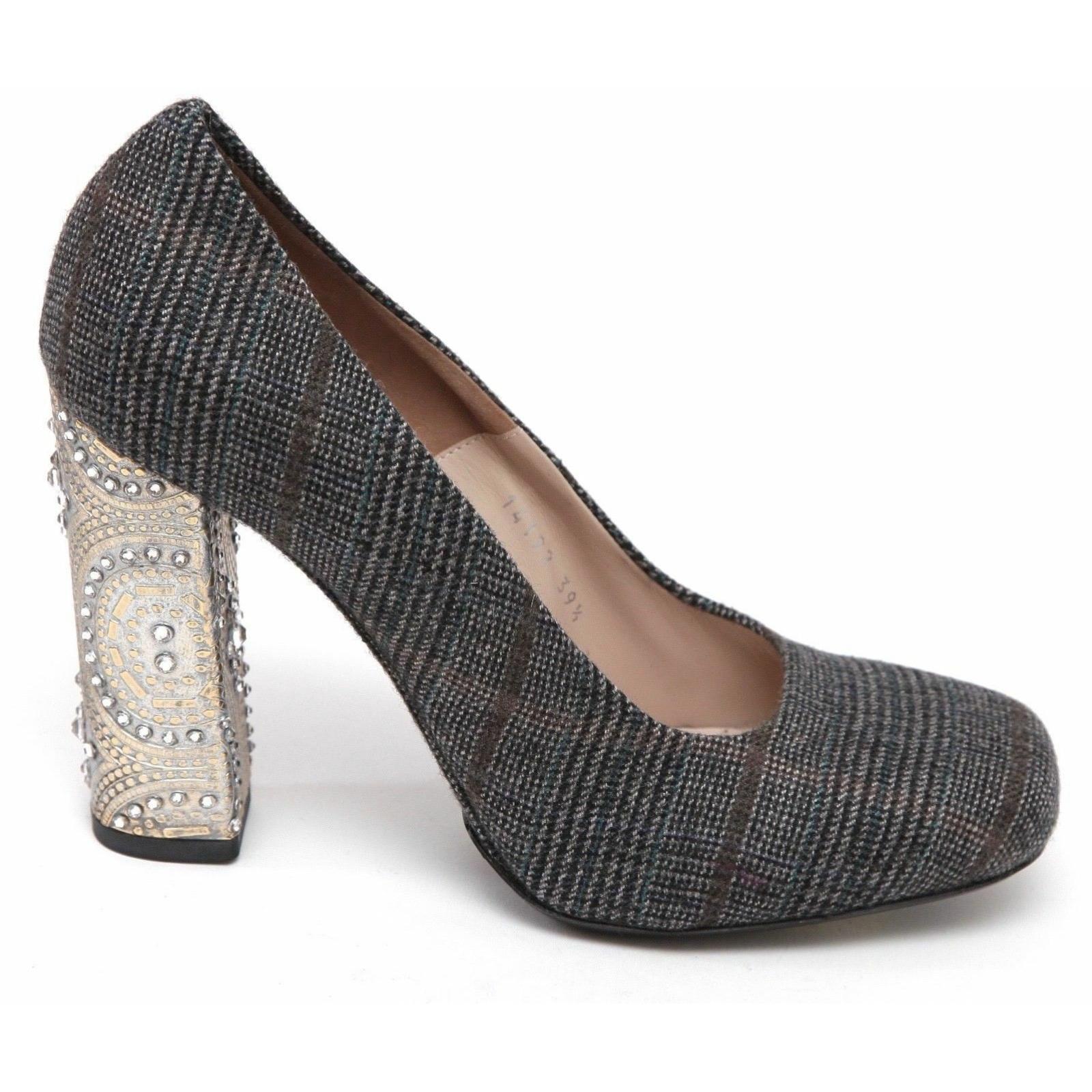 GUARANTEED AUTHENTIC DRIES VAN NOTEN WOOL PLAID PUMP WITH CRYSTAL HEEL EMBELLISHMENT

Retail excluding tax $985

Design:
- Plaid check pattern wool uppers in grey, brown and blue colors.
- Square toe.
- Crystal embellished block heel.
- Leather