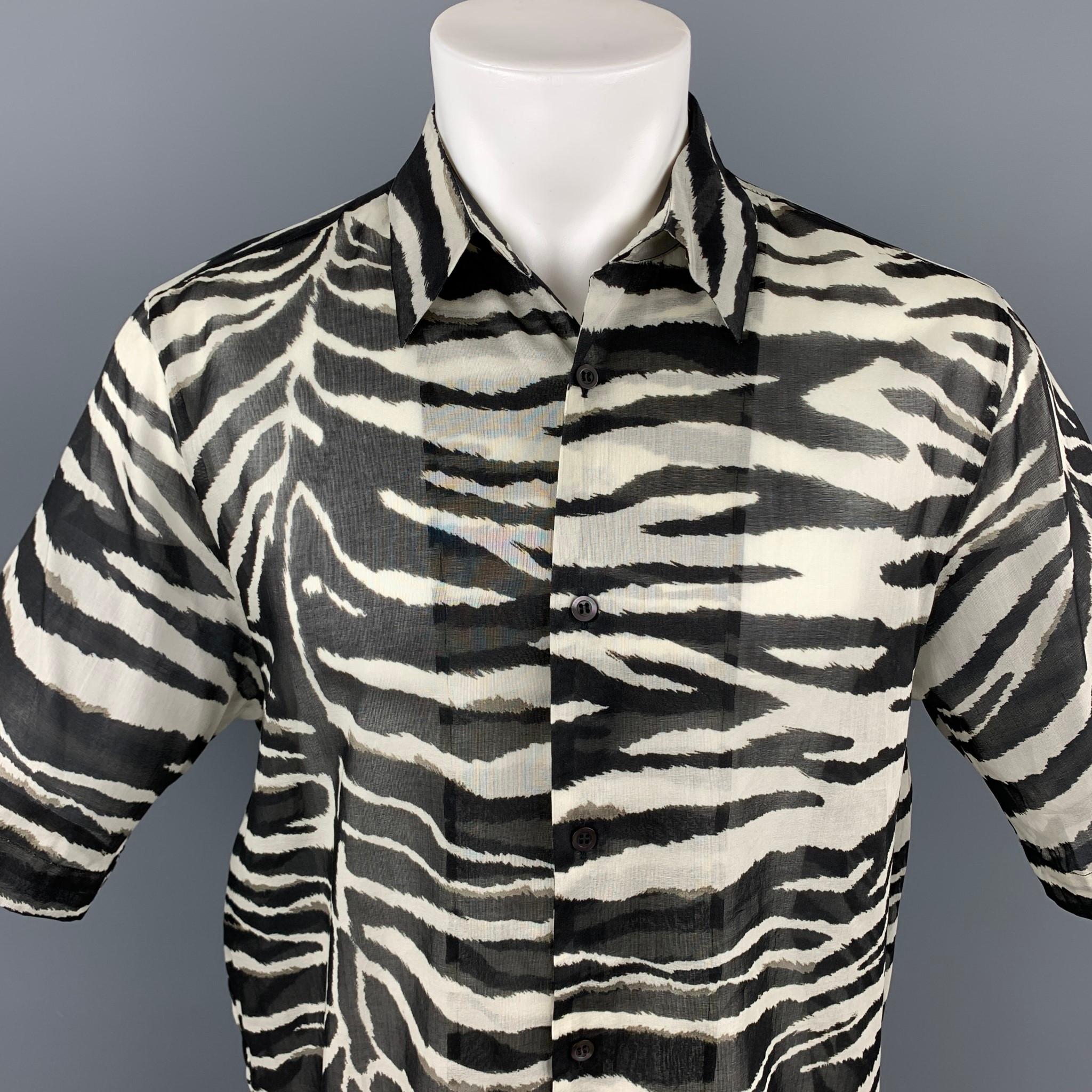 DRIES VAN NOTEN S/S 20 short sleeve shirt comes in a black & white zebra print cotton featuring a button up style and a pointed collar. Made in Portugal.

New With Tags.
Marked: 50
Original Retail Price: $470.00

Measurements:

Shoulder: 18