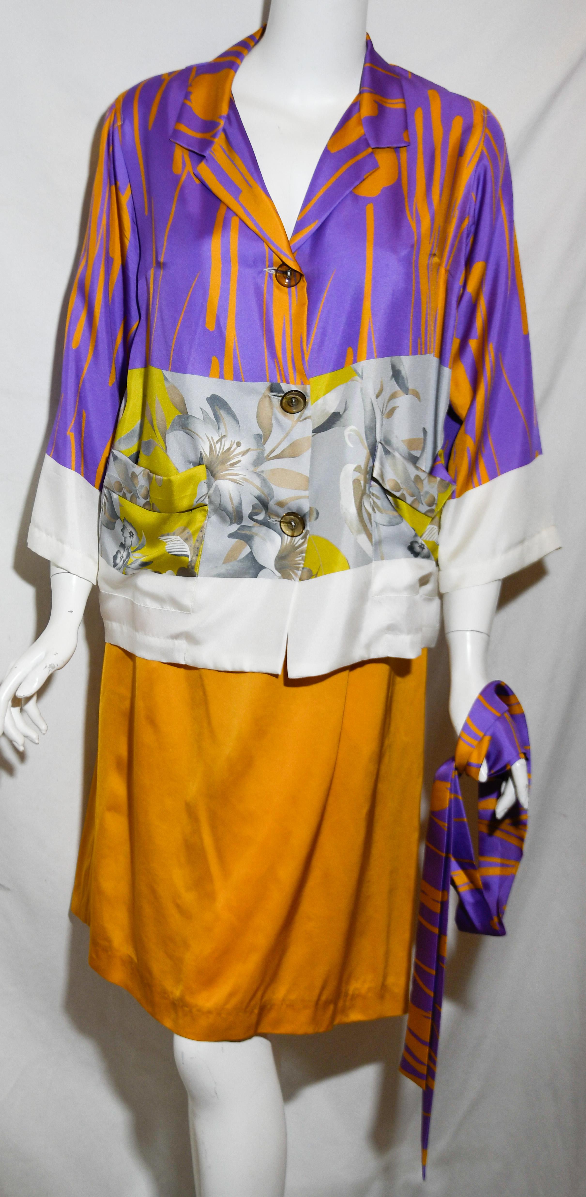 Dries Van Noten orange and purple silk short kimono style skirt suit incorporates purple and orange bold stripes transitioning to yellow and white floral print.  The jacket is tied at the waist by a sash, of same print and contains 3/4  sleeves 