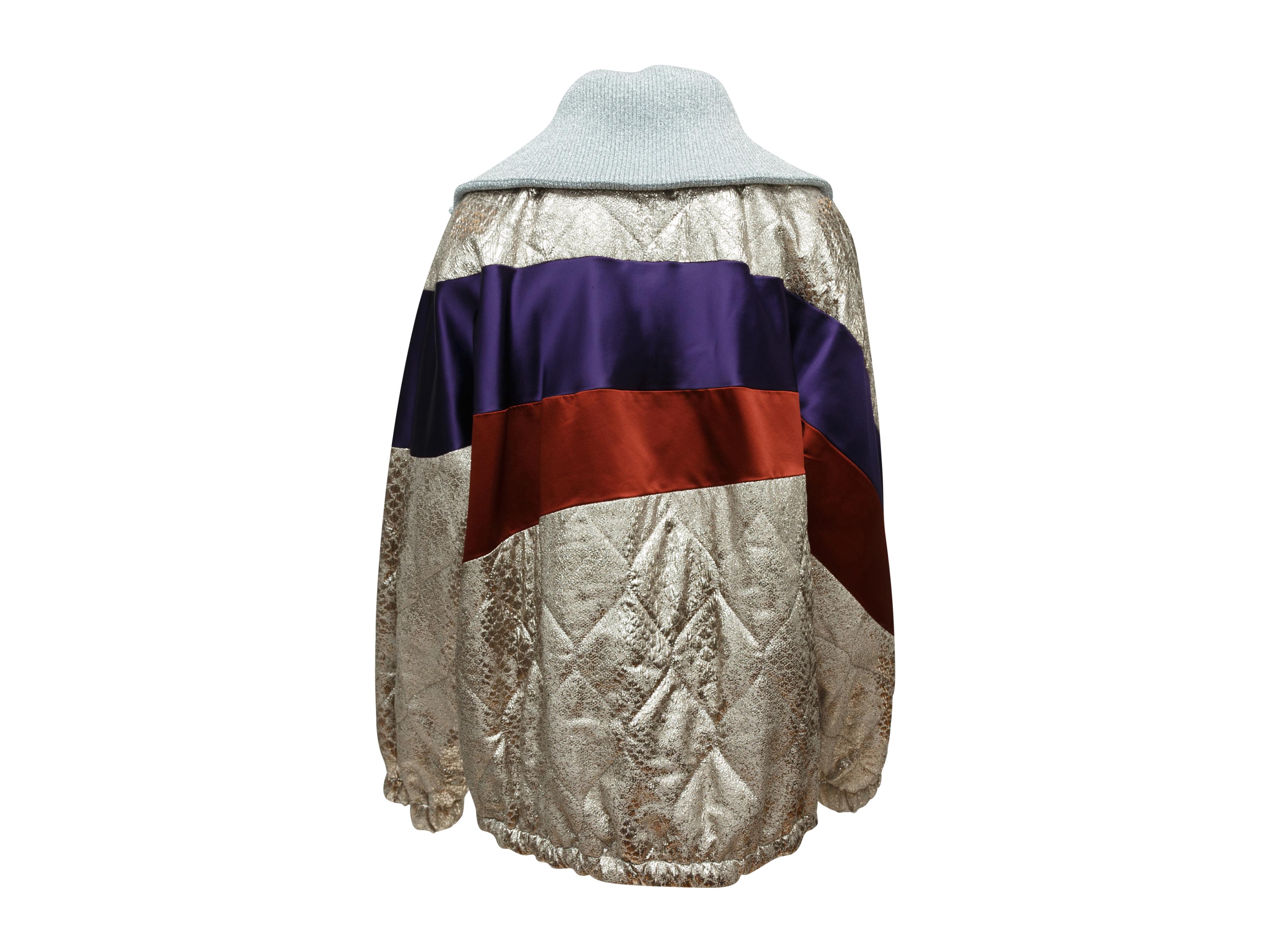 Product details: Metallic silver, red and purple satin bomber jacket by Dries Van Noten. Oversize collar. Drawstring at hem. Zip closure at center front. 44
