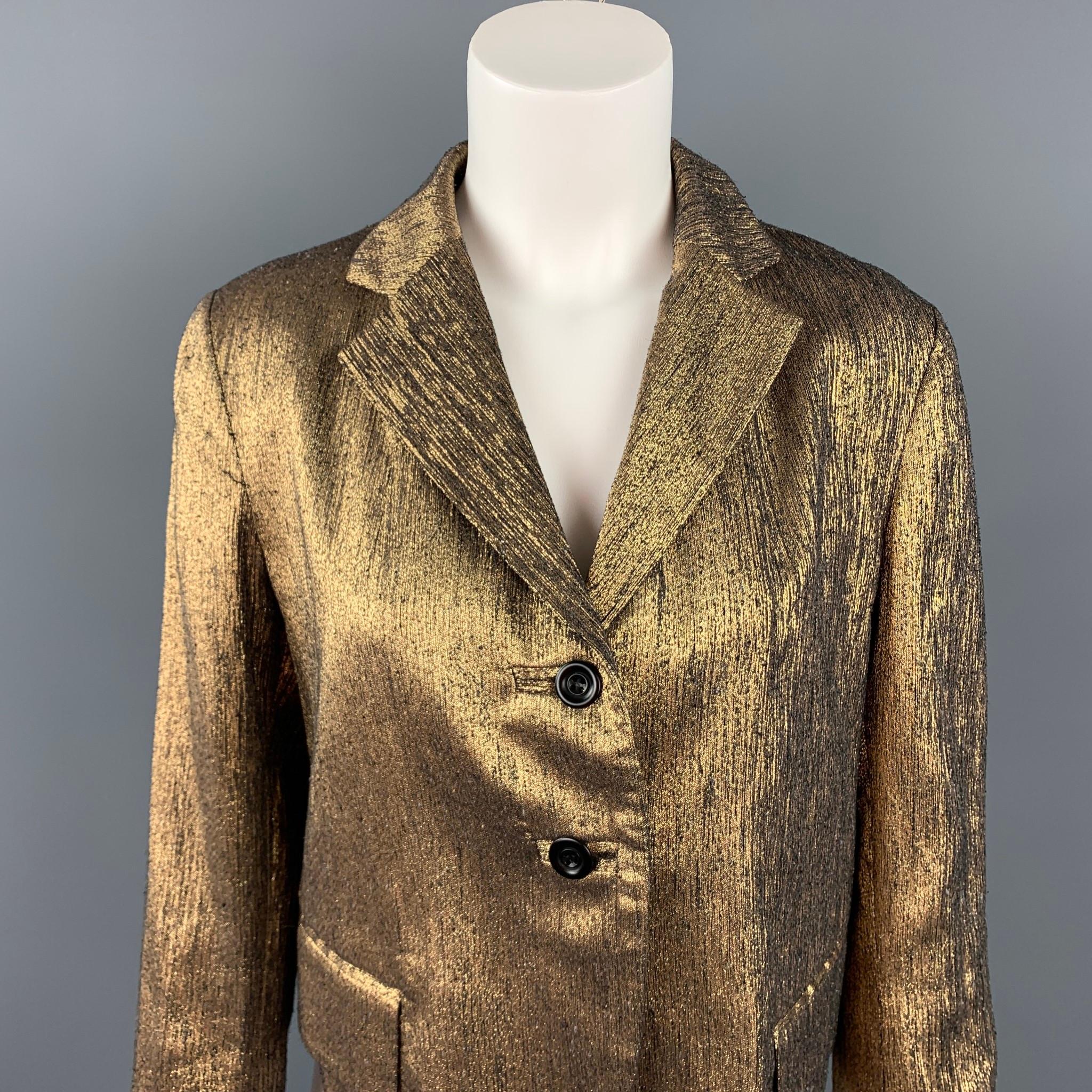 DRIES VAN NOTEN blazer comes in a gold textured silk blend with a full liner featuring a notch lapel, flap pockets, and a two button closure. Made in Belgium.

Good Pre-Owned Condition.
Marked: 42

Measurements:

Shoulder: 16 in.
Bust: 38