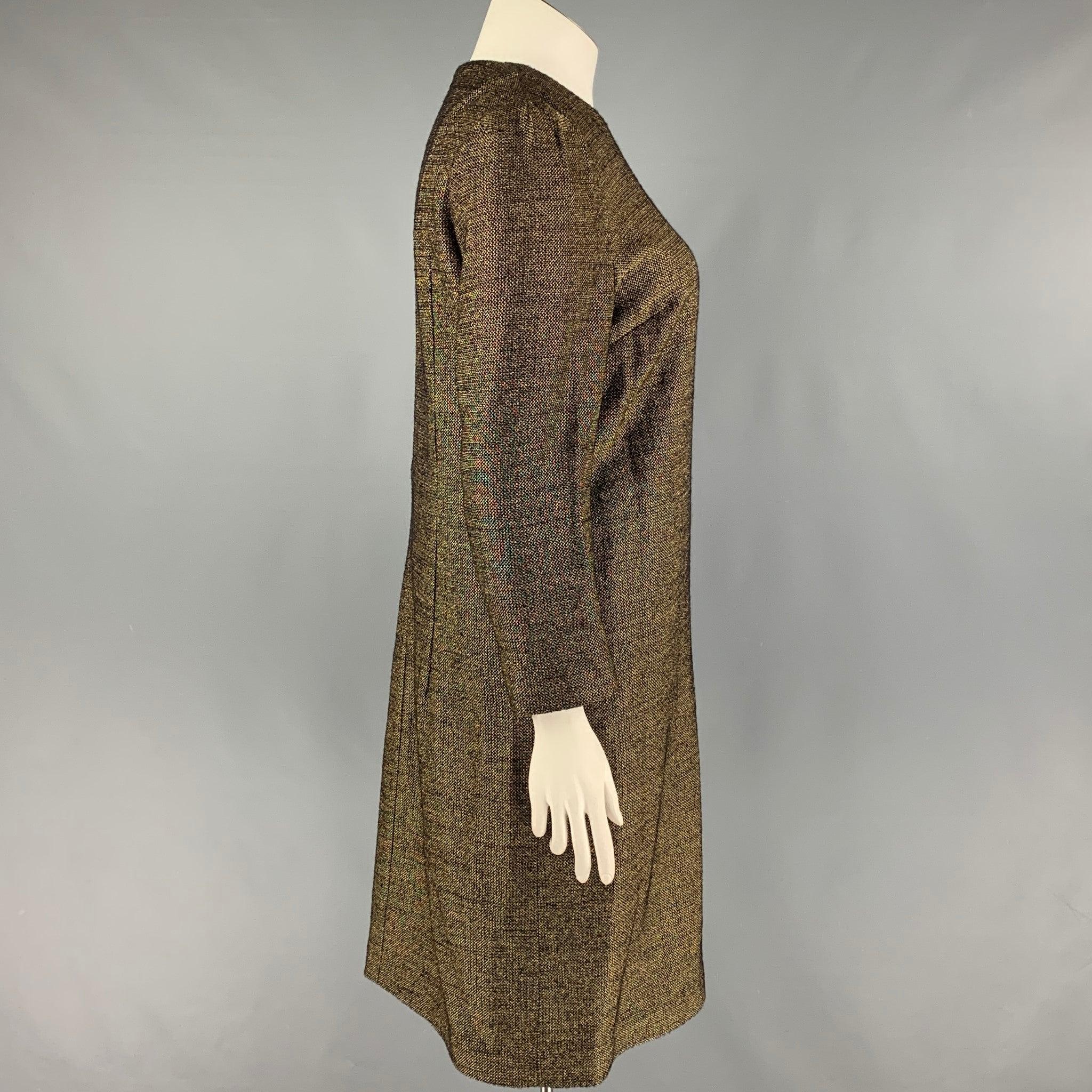 DRIES VAN NOTEN dress comes in a gold wool / viscose featuring a sheath style, bateau neckline, and a back zip up closure.
Very Good
Pre-Owned Condition. 

Marked:   42 

Measurements: 
 
Shoulder: 15.5 inches  Bust: 38 inches  Hip: 40 inches 