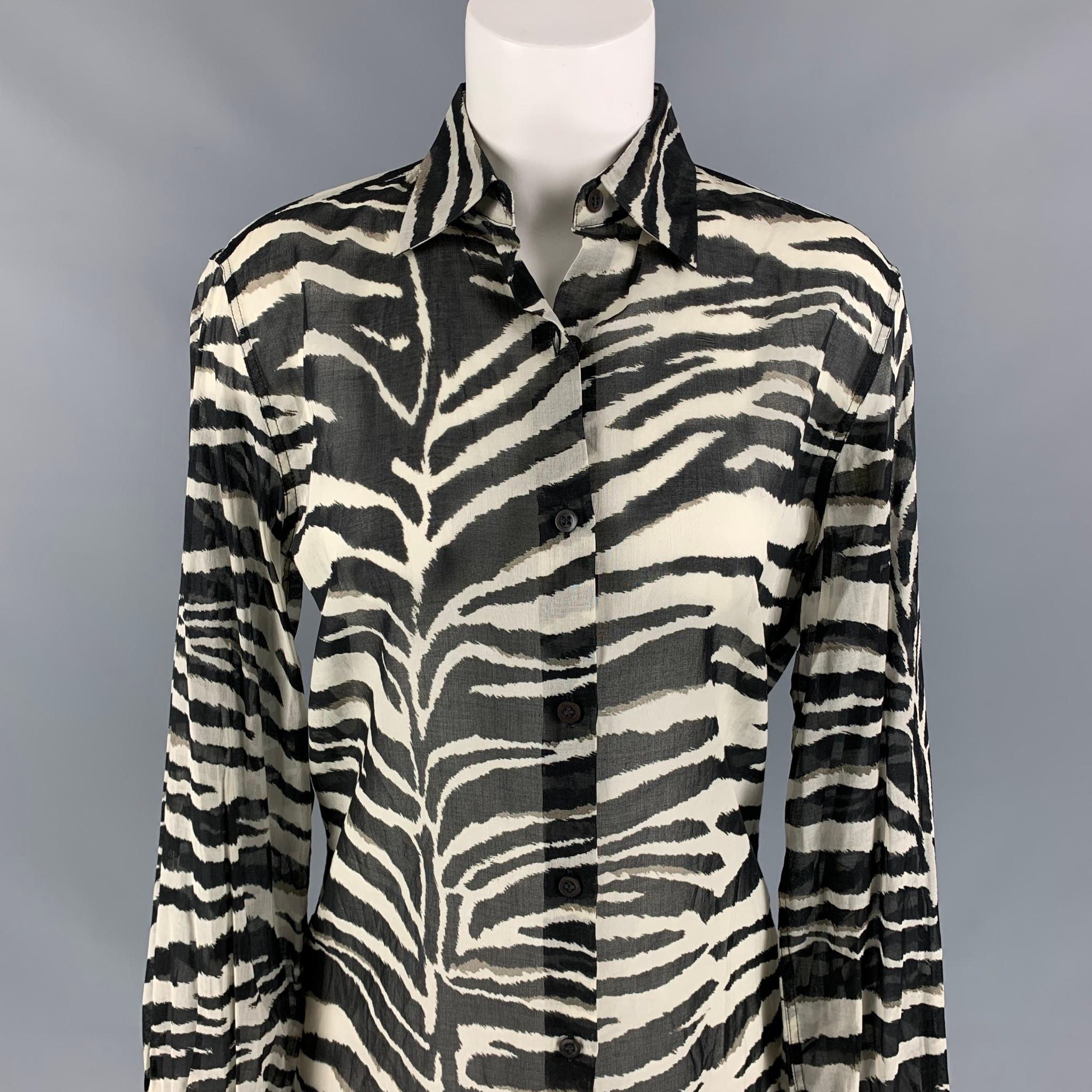 DRIES VAN NOTEN blouse comes in a black & white see through zebra print cotton featuring ruffled cuffs, spread collar, and a hidden button closure. 

New With Tags. 
Marked: 34
Original Retail Price: $725.00

Measurements:

Shoulder: 17 in.
Bust: 38