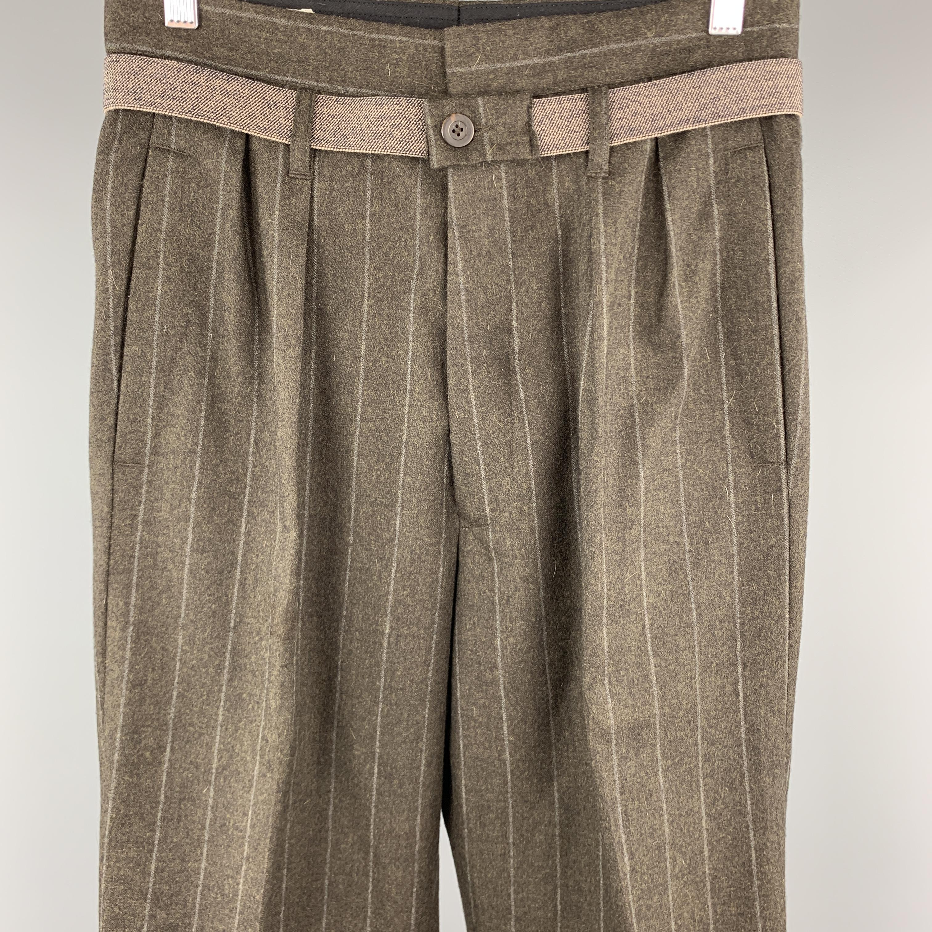 DRIES VAN NOTEN dress pants come in earthy brown wool cashmere blend with an elastic belt, wide cuffed leg, and double pleat. Made in Belgium.

Excellent Pre-Owned Condition.
Marked: IT 46

Measurements:

Waist: 29 in.
Rise: 14.5 in.
Inseam: 28