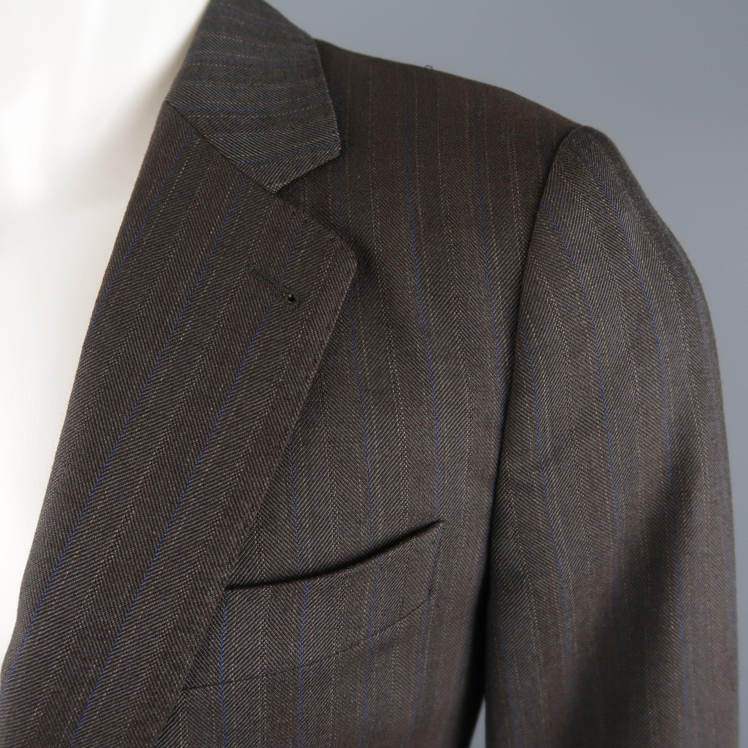 DRIES VAN NOTEN sport coat comes in brown and blue striped wool blend twill with a single breasted, two button closure, top stitching, and functional button cuffs. Made in Morocco.Excellent Pre-Owned Condition. 

Marked:   IT 46 

Measurements: 
