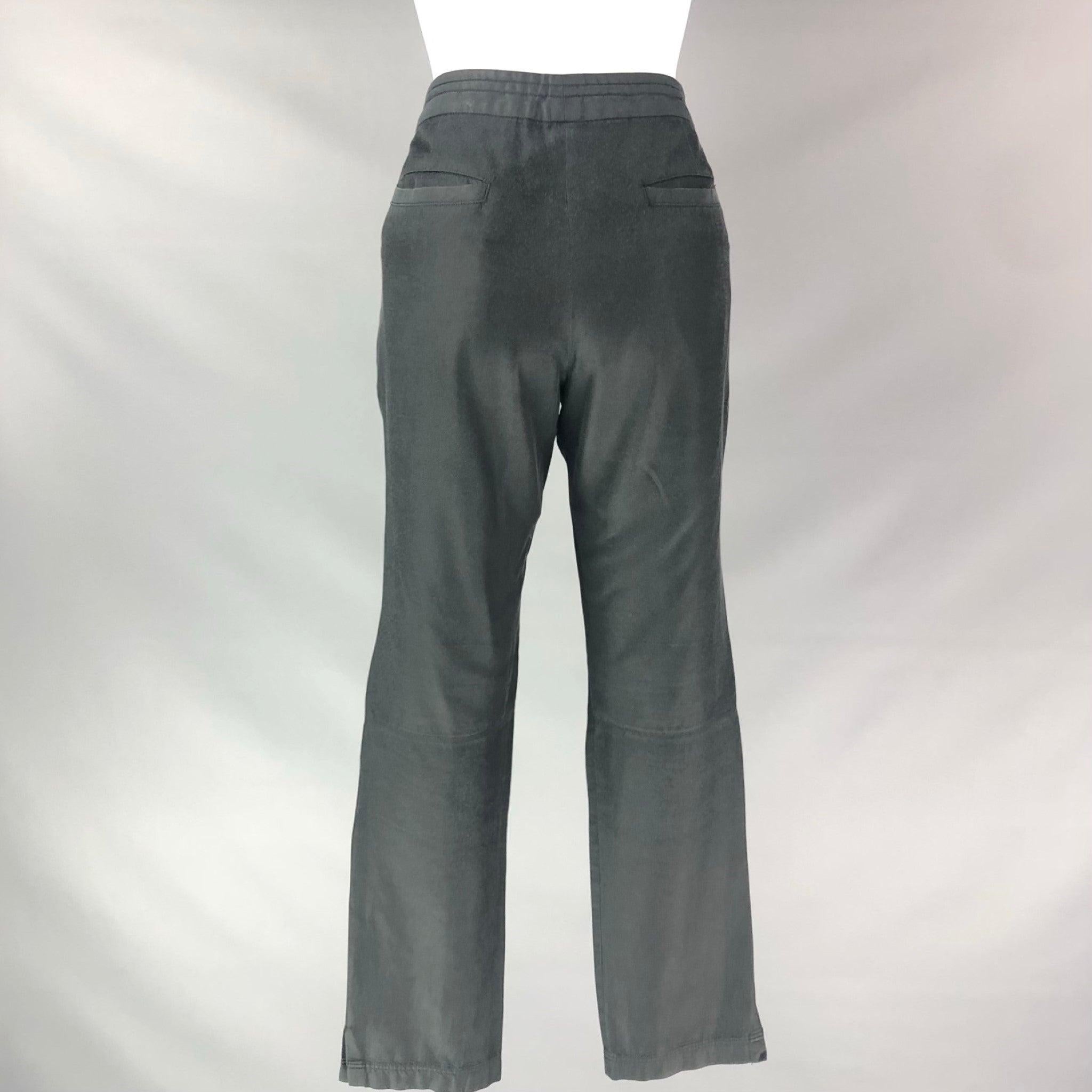 DRIES VAN NOTEN Straight casual pants comes in a black cotton and rayon featuring rectangular patch pockets, knee patch, Flat Front, draw strings zip up closure. Very Good Pre-Owned Condition. 

Marked:   36 

Measurements: 
  Waist: 30 inRise: 9