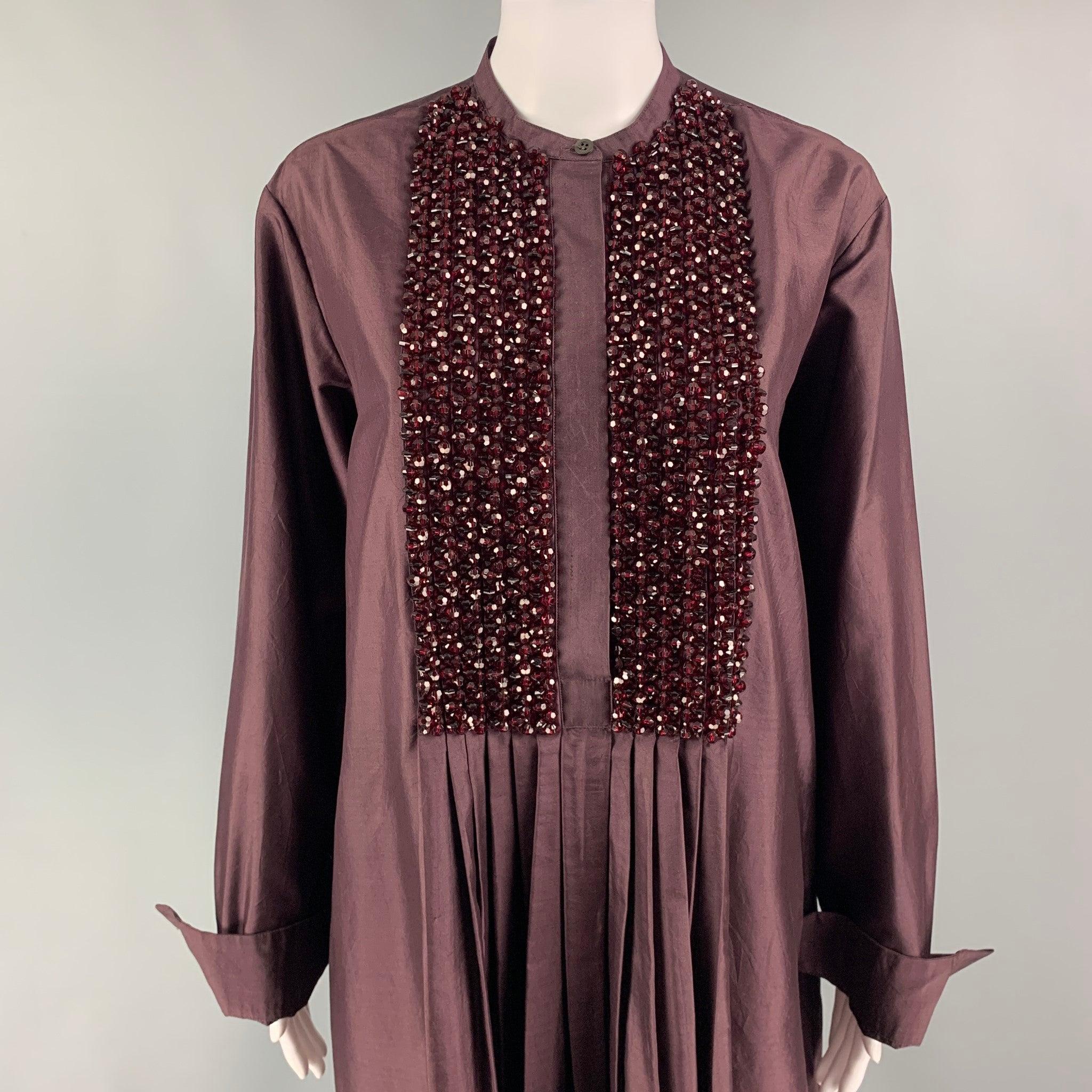 DRIES VAN NOTEN dress comes in a burgundy silk featuring a tunic style, pleated, beaded panel, slit pockets, and a front hidden placket closure.
Excellent
Pre-Owned Condition. 

Marked:   36 

Measurements: 
 
Shoulder: 17 inches Bust:
44 inHip: 46