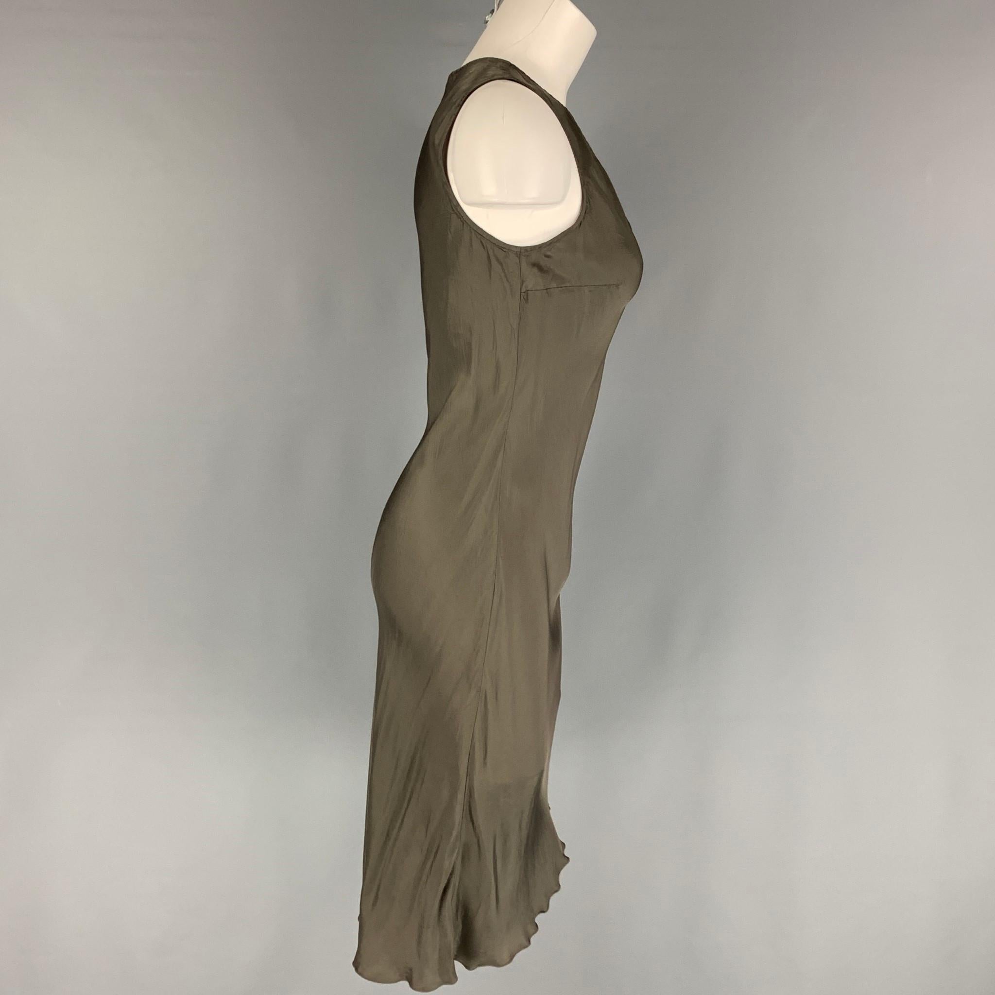 DRIES VAN NOTEN slip dress comes in a grey material featuring a v-neck. 

Very Good Pre-Owned Condition. Fabric tag removed.
Marked: 36

Measurements:

Shoulder: 12 in.
Bust: 26 in.
Waist: 26 in.
Hip: 30 in.
Length: 45 in. 