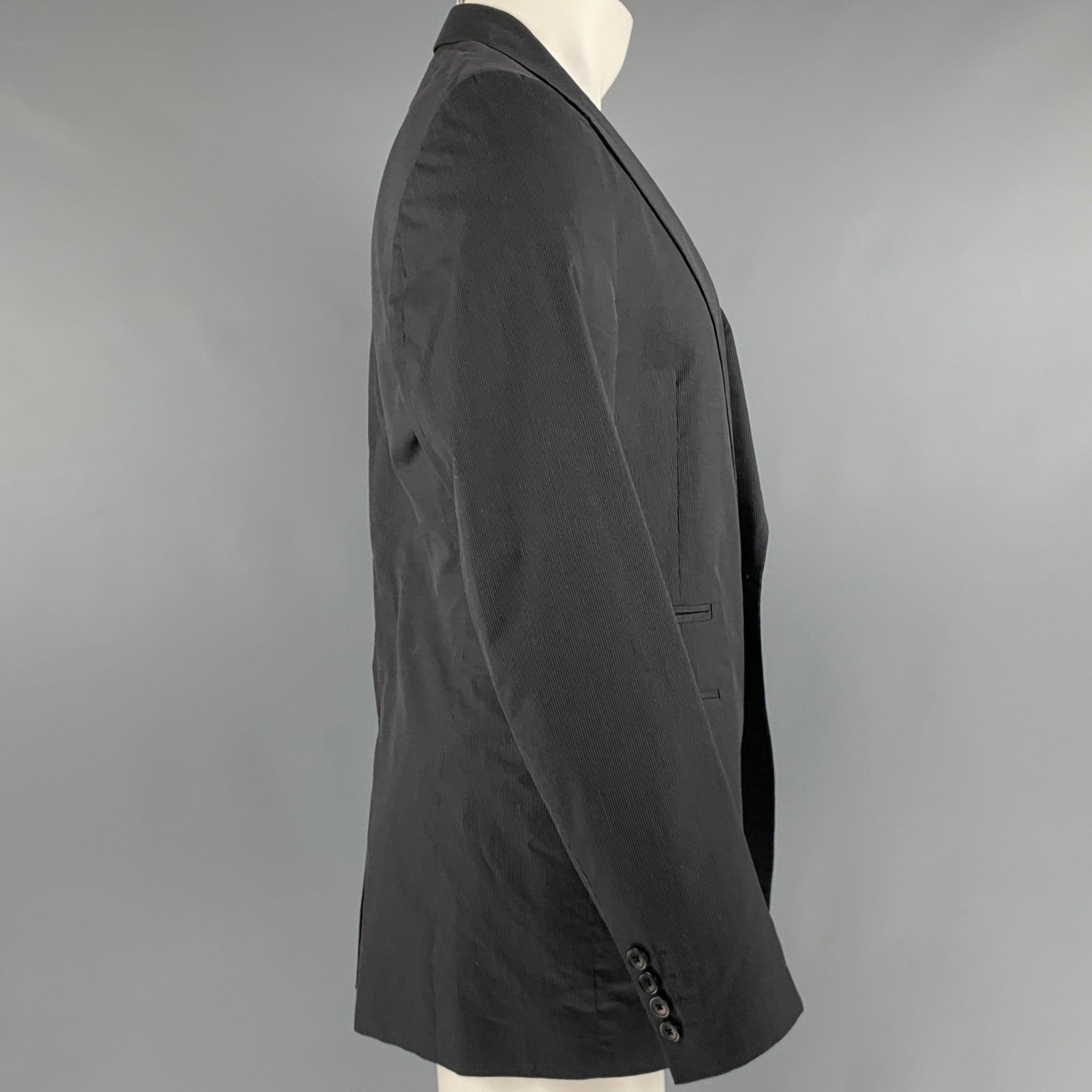 DRIES VAN NOTEN sport coat
in a black cotton fabric featuring grey stripe pattern, notch lapel, and double button closure.Very Good Pre-Owned Condition. Marks on back and minor mark on front. 

Marked:   50 

Measurements: 
 
Shoulder: 17.5 inches