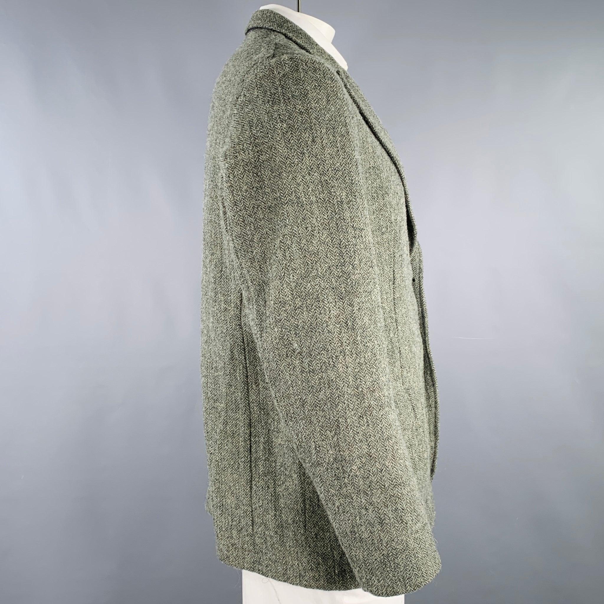DRIES VAN NOTEN sport coat
in a green wool featuring a herringbone pattern, peak lapel, ventless back, and double button closure. Made in Slovenia.Excellent Pre-Owned Condition. 

Marked:   IT 54 

Measurements: 
 
Shoulder: 18.5 inches Chest: 44