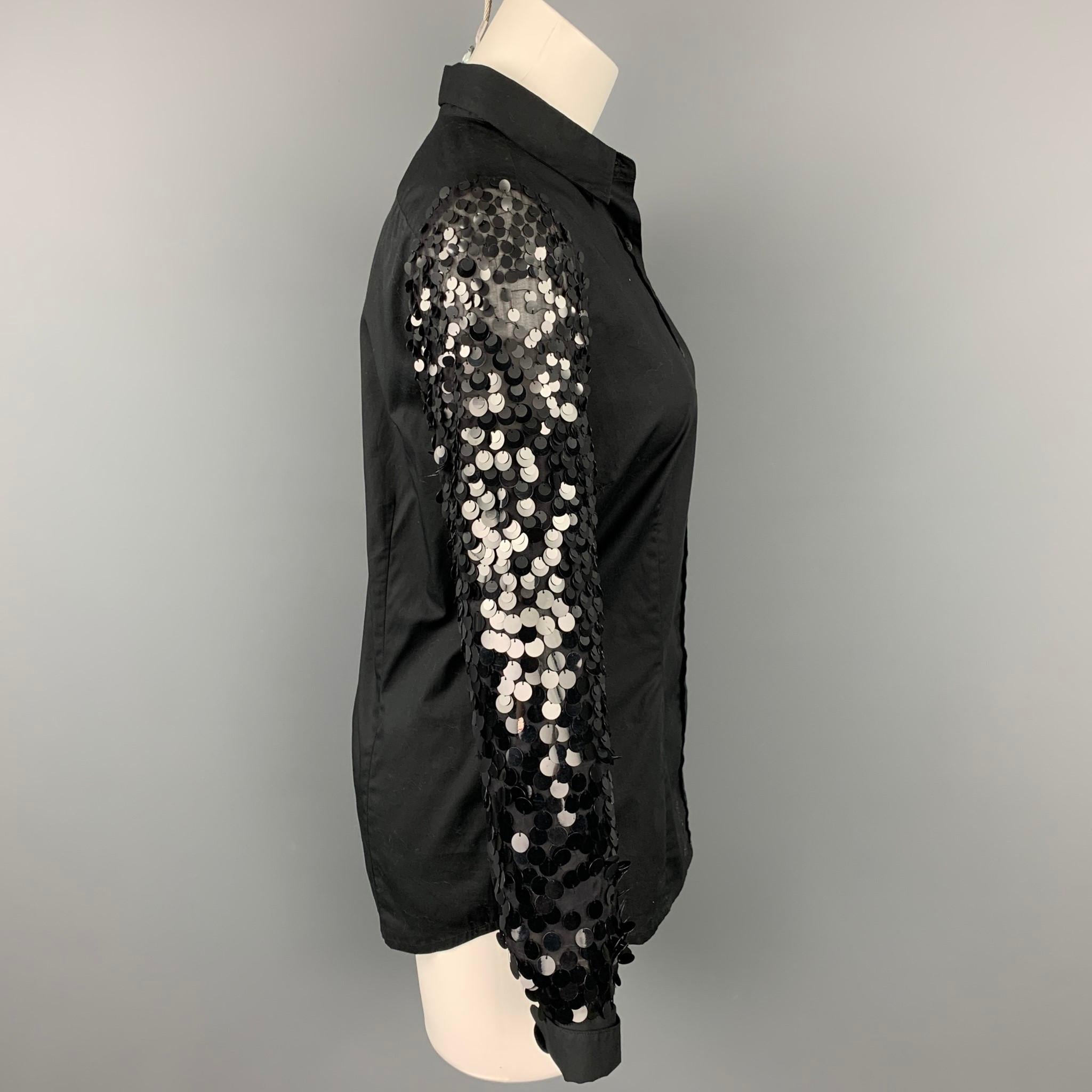 DRIES VAN NOTEN blouse comes in a black cotton / silk featuring sequined sleeves featuring a spread collar and a buttoned closure.

Very Good Pre-Owned Condition.
Marked: 36

Measurements:

Shoulder: 15 in.
Bust: 34 in.
Sleeve: 24 in.
Length: 25 in. 