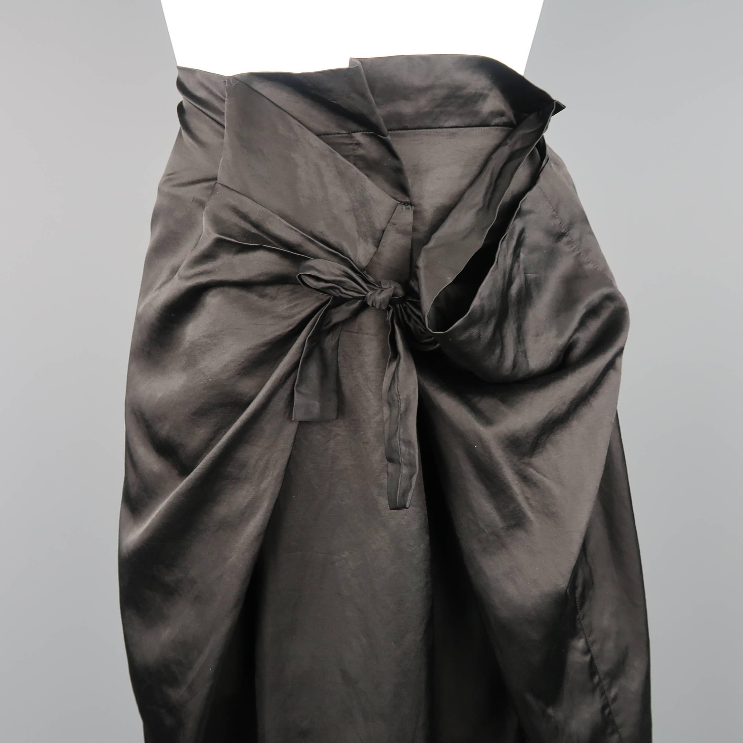 This avant garde DRIES VAN NOTEN A line skirt comes in a black taffeta with a unique double wrap tie construction, leaving a draped and gathered side panel. Discoloration on back. As-is. Made in France.
 
Fair Pre-Owned Condition.
Marked: EU 42
