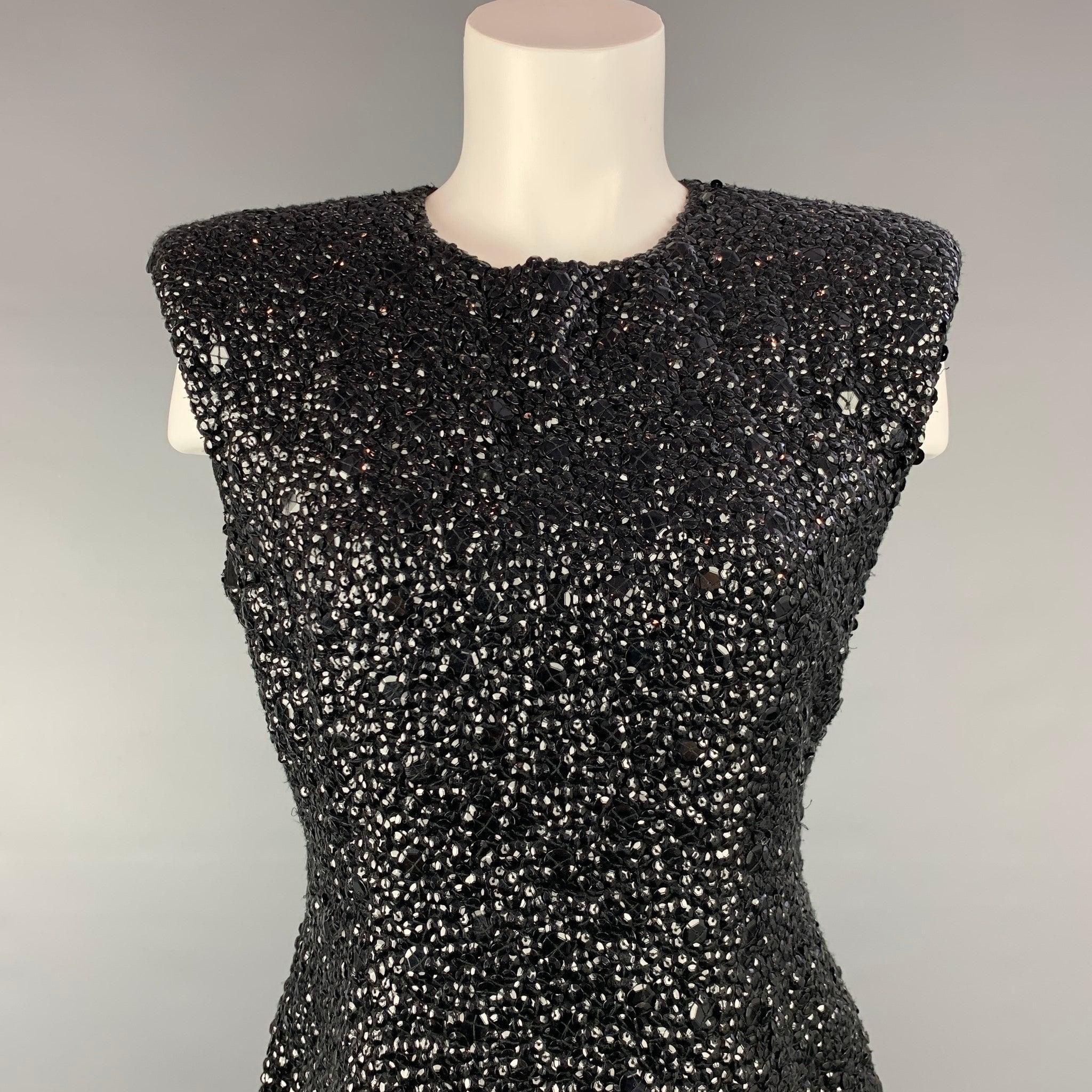 DRIES VAN NOTEN dress top comes in a black sequined textured viscose with a full silk liner featuring a sleeveless style and a back zip up closure.New With Tags. 

Marked:   38 

Measurements: 
 
Shoulder: 17.5 inches  Bust: 34 inches  Length: 24