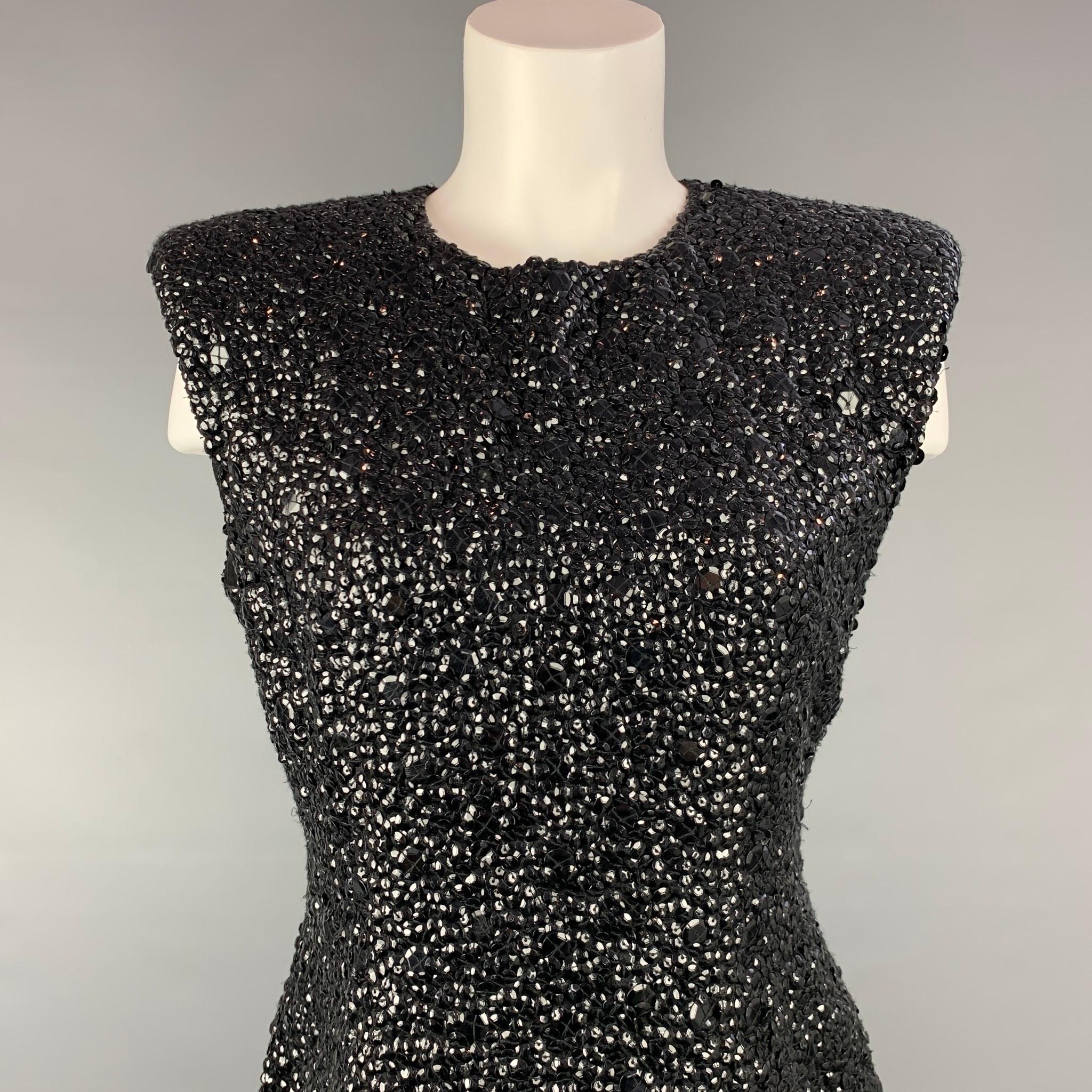 DRIES VAN NOTEN dress top comes in a black sequined textured viscose with a full silk liner featuring a sleeveless style and a back zip up closure.

New With Tags.
Marked: 38
Original Retail Price: $1,600.00

Measurements:

Shoulder: 17.5 in.
Bust: