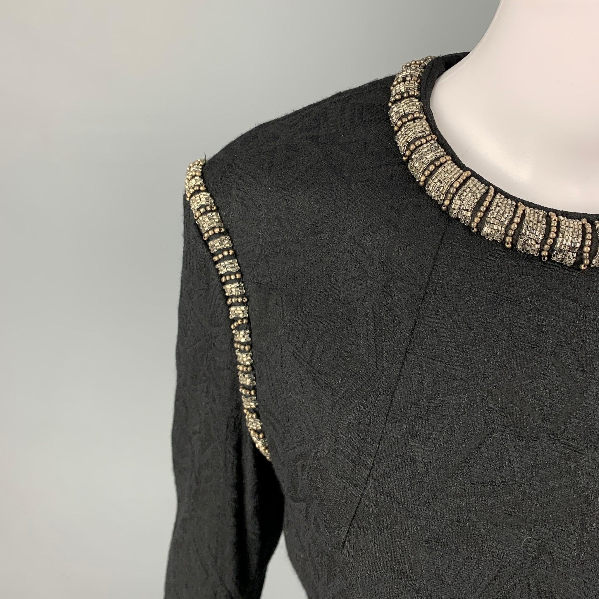 DRIES VAN NOTEN dress top comes in a black jacquard wool blend featuring a beaded trim, crew-neck, and a back zip up closure.
Excellent
Pre-Owned Condition. 

Marked:   38 

Measurements: 
 
Shoulder:
16.5 inches Bust: 34 inches Sleeve: 22.5 inches