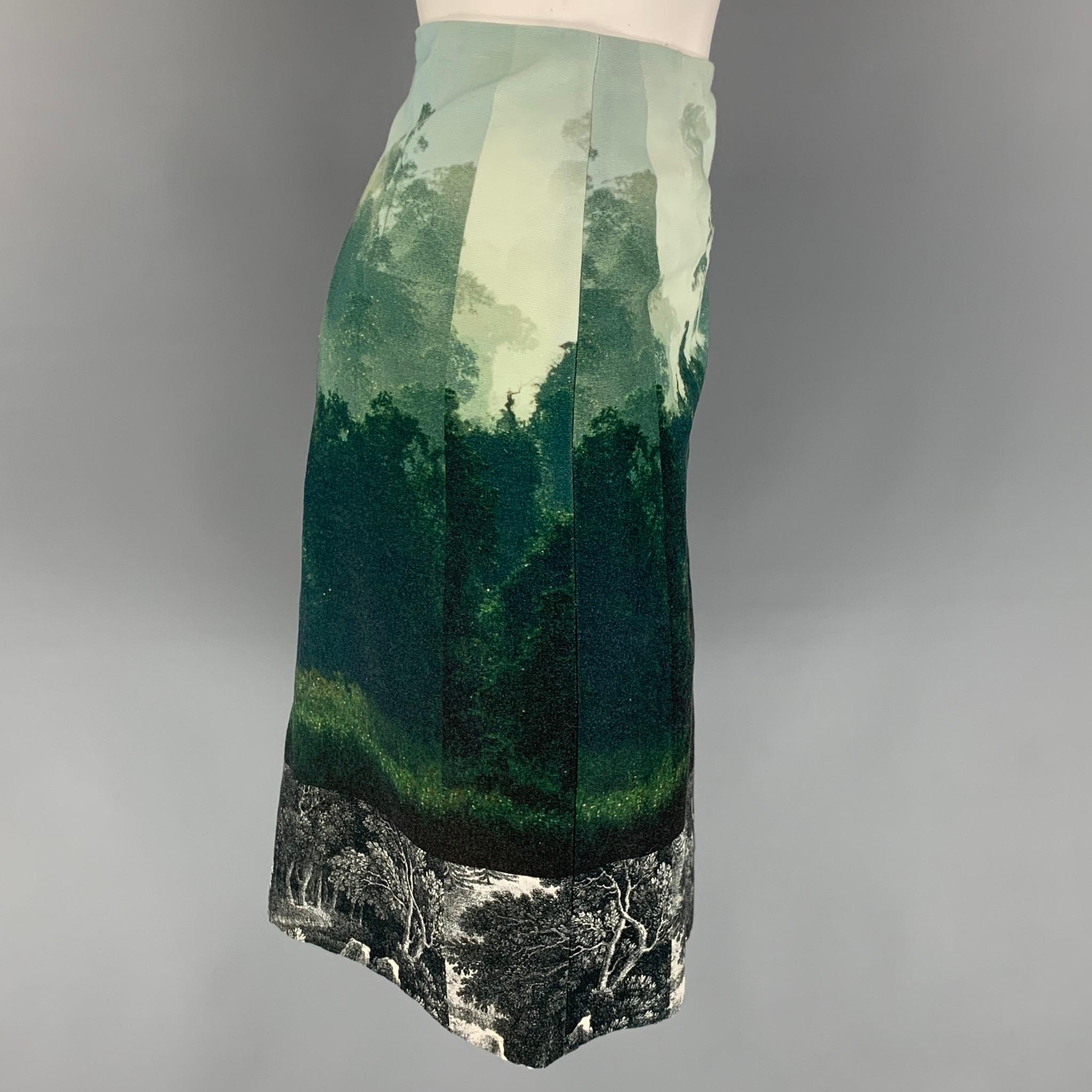 DRIES VAN NOTEN skirt comes in a green & blue tapestry cotton with a slip liner featuring an a-line style, black & white panel, side slit, and a back zip up closure. 

Very Good Pre-Owned Condition.
Marked: 38

Measurements:

Waist: 30 in.
Hip: 36