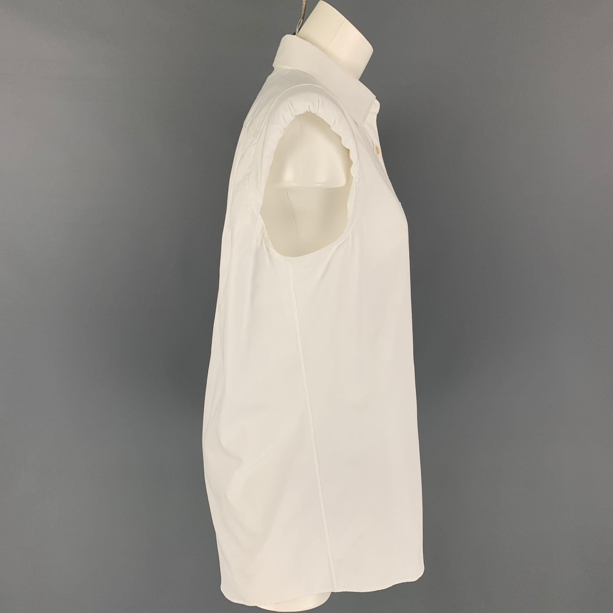 DRIES VAN NOTEN shirt comes in a white cotton featuring a sleeveless style, shoulder pads, front pocket, and a buttoned closure.
Very Good
Pre-Owned Condition. 

Marked:   38 

Measurements: 
 
Shoulder:
16 inches  Bust: 38 inches  Length: 31.5