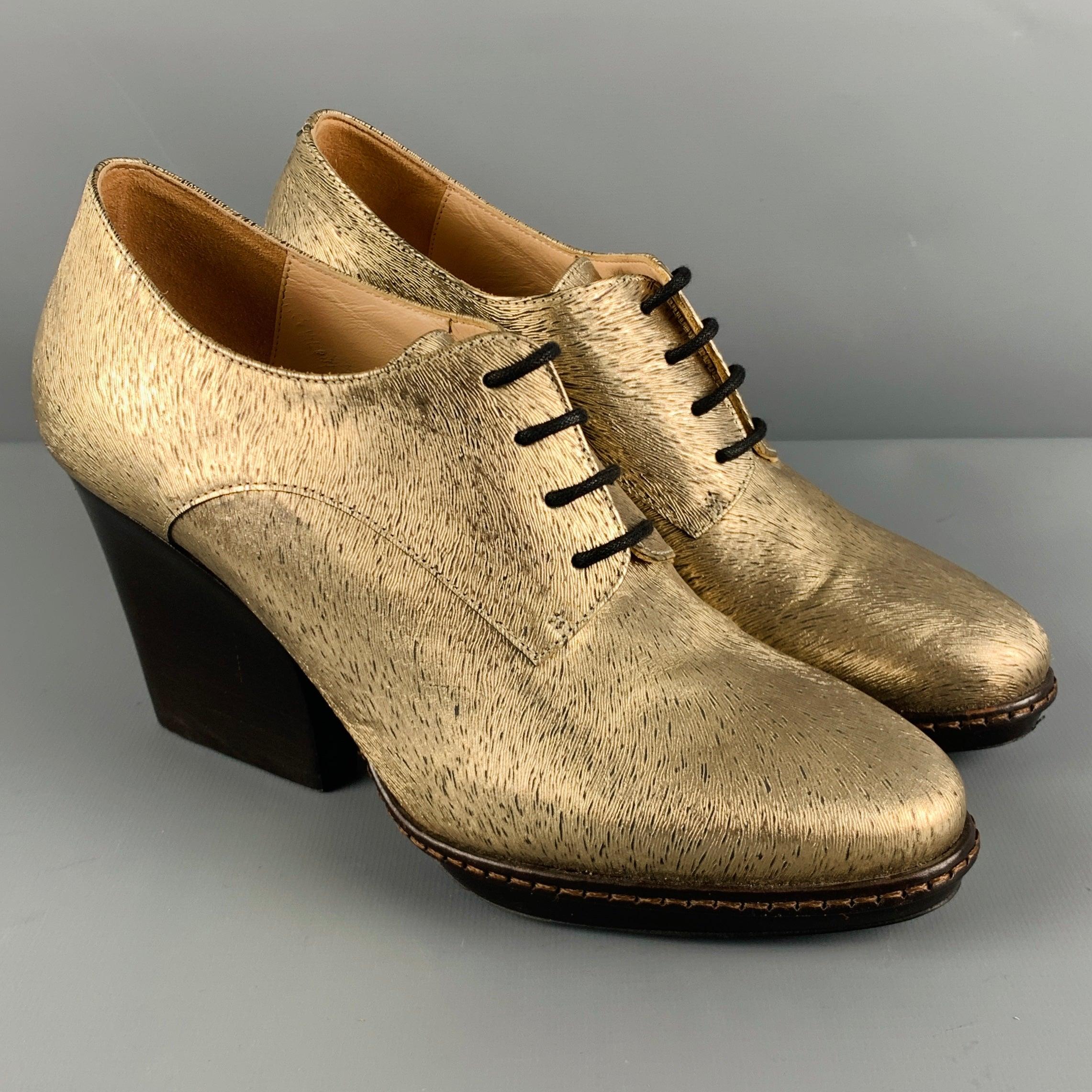 DRIES VAN NOTEN booties
in a metallic gold and brown fabric featuring a textured animal print pattern, platform with chunky heel, and lace-up closure.
Made in Italy.Very Good Pre-Owned Condition. Scuff mark on back of left shoe. 

Marked:   14760