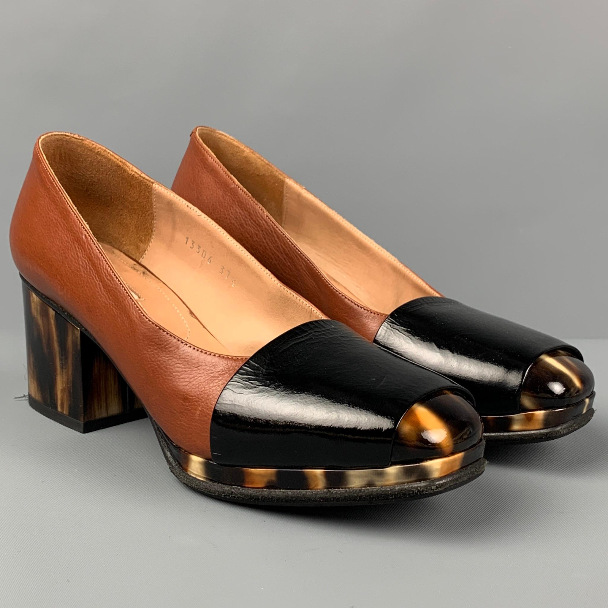 DRIES VAN NOTEN pumps comes in a tan leather featuring a black trim and a chunky tortoiseshell heel. Made in Italy. Includes dust bag.

Very Good Pre-Owned Condition.
Marked: 13306 / 37.5

Measurements:

Heel: 2.5 in. 