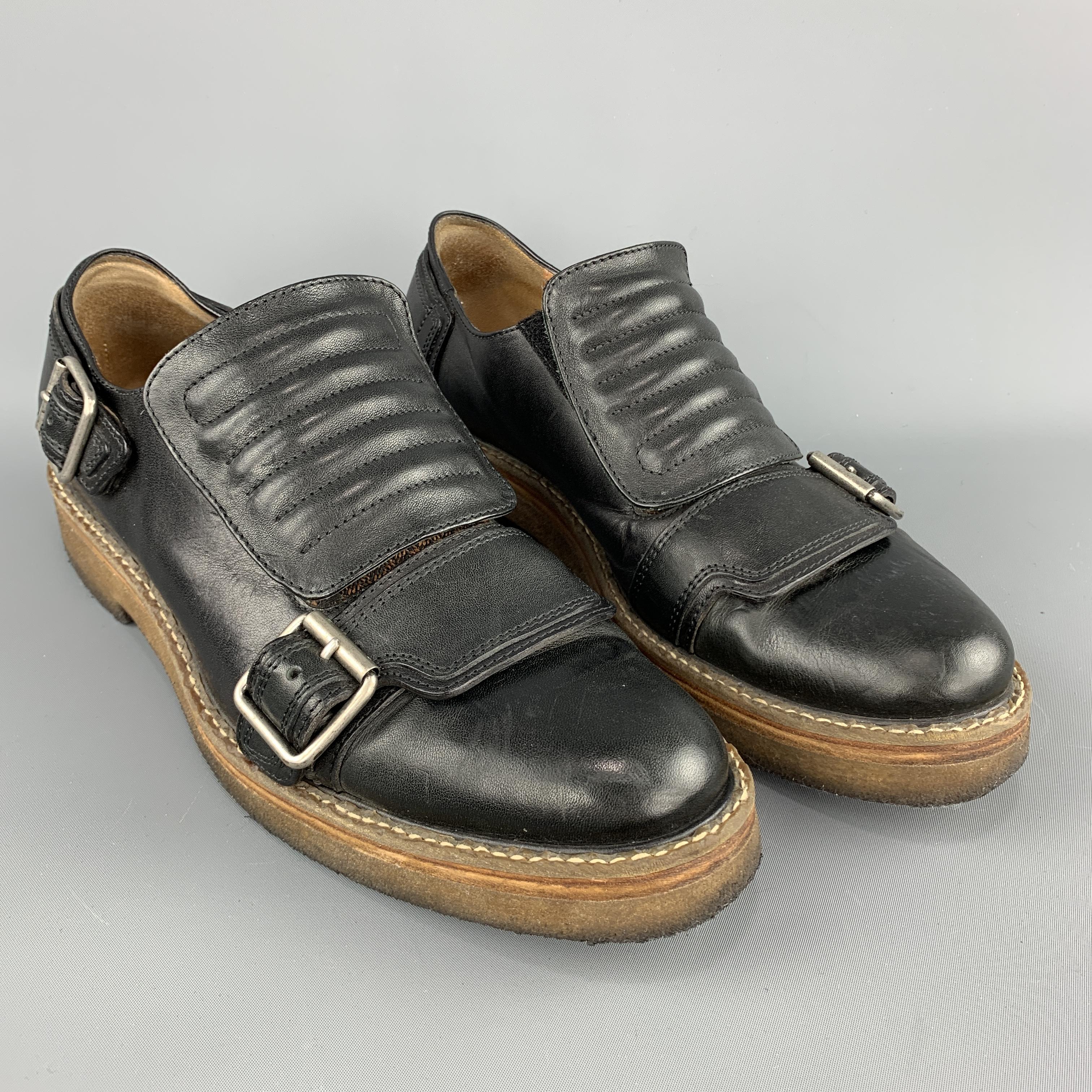 DRIES VAN NOTEN loafers come in black leather with silver tone buckle strap details, thick quilted strap closure, and tan crepe sole. Made in Italy.  Retails at $945

Good Pre-Owned Condition.
Marked: IT 41

Outsole: 12 x 4.25 in.