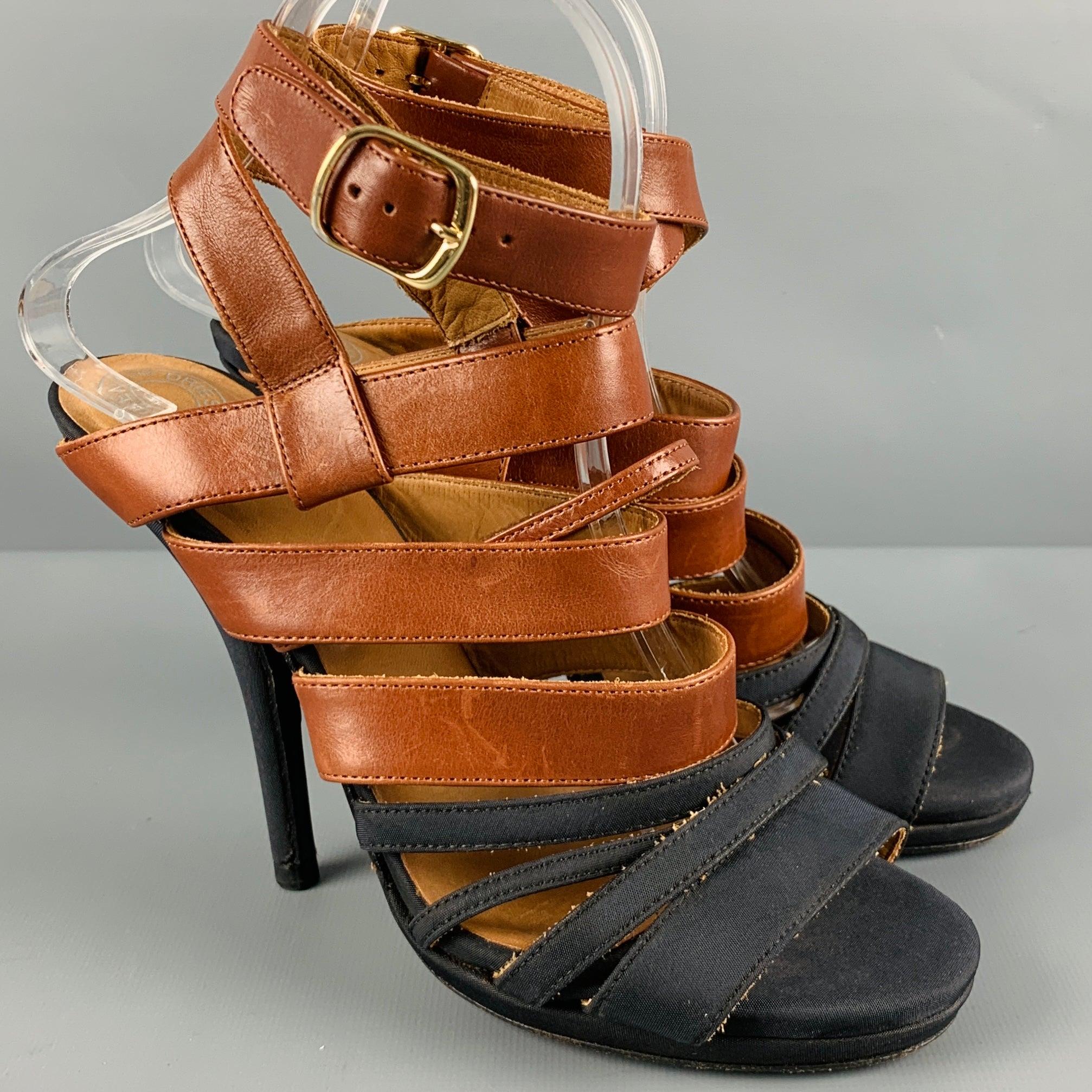 DRIES VAN NOTEN sandals
in a brown leather and black fabric featuring a two-tone strappy style, platform, and ankle strap buckle closure.Excellent Pre-Owned Condition. 

Marked:   38 

Measurements: 
  Platform: 1 cm.Heel: 4.5 inches 
  
  
