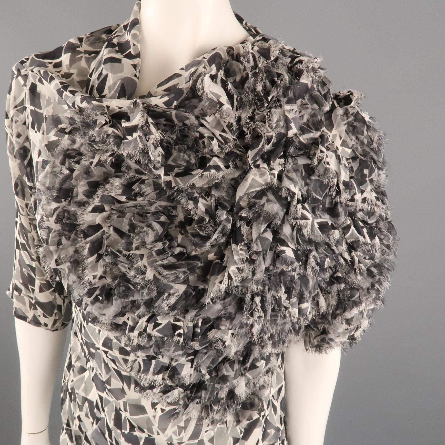 DRIES VAN NOTEN blouse come in gray geometric print silk chiffon with a high draped neck, short sleeves, oversized silhouette, and fringed applique shoulder.
 
Excellent Pre-Owned Condition.
Marked: IT 40
 
Measurements:
 
Shoulder: 17 in.
Bust: 38