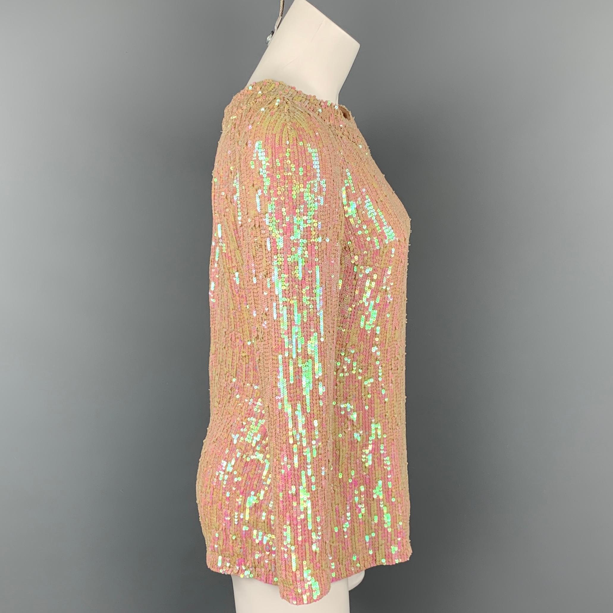 DRIES VAN NOTEN dress top comes in a iridescent & nude sequin silk featuring long sleeves and a back hook & loop closure.

Very Good Pre-Owned Condition.
Marked: 38

Measurements:

Shoulder: 17.5 in.
Bust: 36 in.
Sleeve: 21 in.
Length: 24 in. 