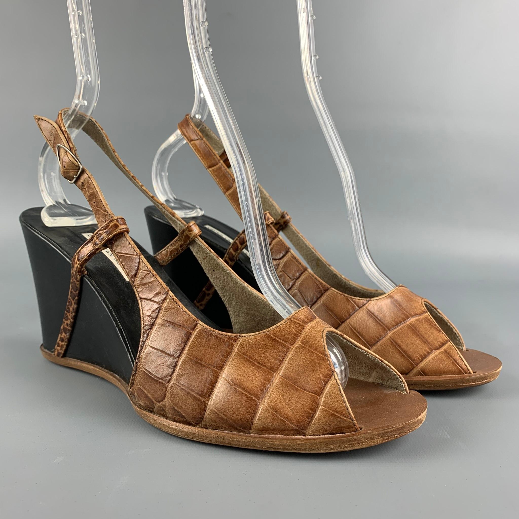 DRIES VAN NOTEN sandals comes in a tan & black embossed leather featuring a peep toe, strap closure, and a wedge heel. 

Good Pre-Owned Condition.
Marked: 38

Measurements:

Heel: 3 in. 