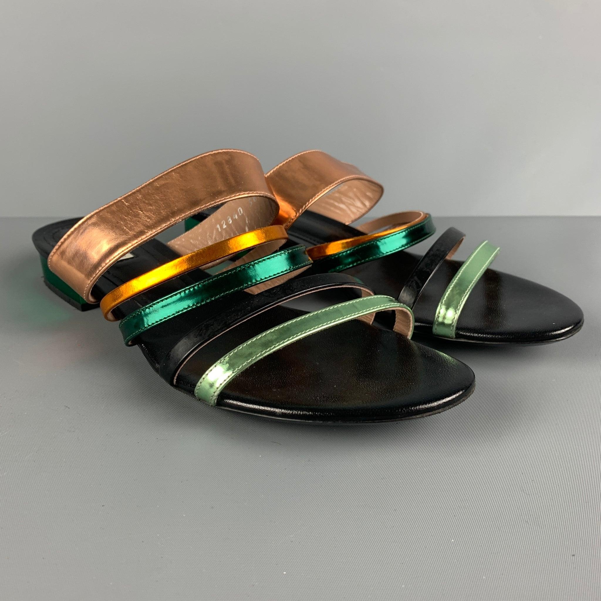 DRIES VAN NOTEN sandals comes in a black, green and gold patent leather featuring a strappy style and one inch metallic green heels. Made in Italy.Very Good Pre-Owned Condition. Moderate Wear. 

Marked:   38 1/2Heel: 1 inches  
  
  
 
Reference: