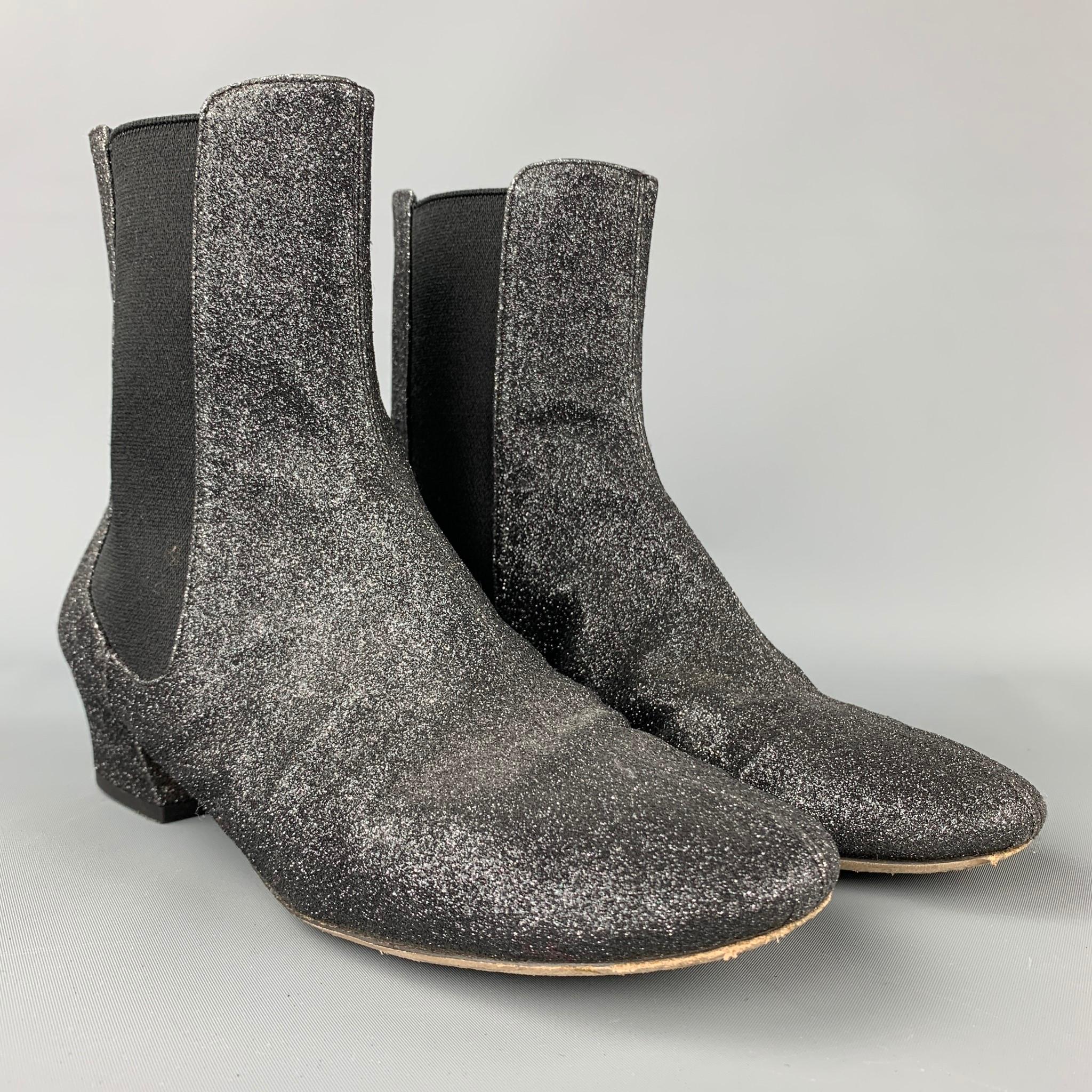 DRIES VAN NOTEN booties comes in a black leather with a glittered design featuring a chelsea style, slip on, and a covered heel. Comes with dust bag. Made in Italy.

Very Good Pre-Owned Condition.
Marked: EU 39

Measurements:

Heel: 2 in.