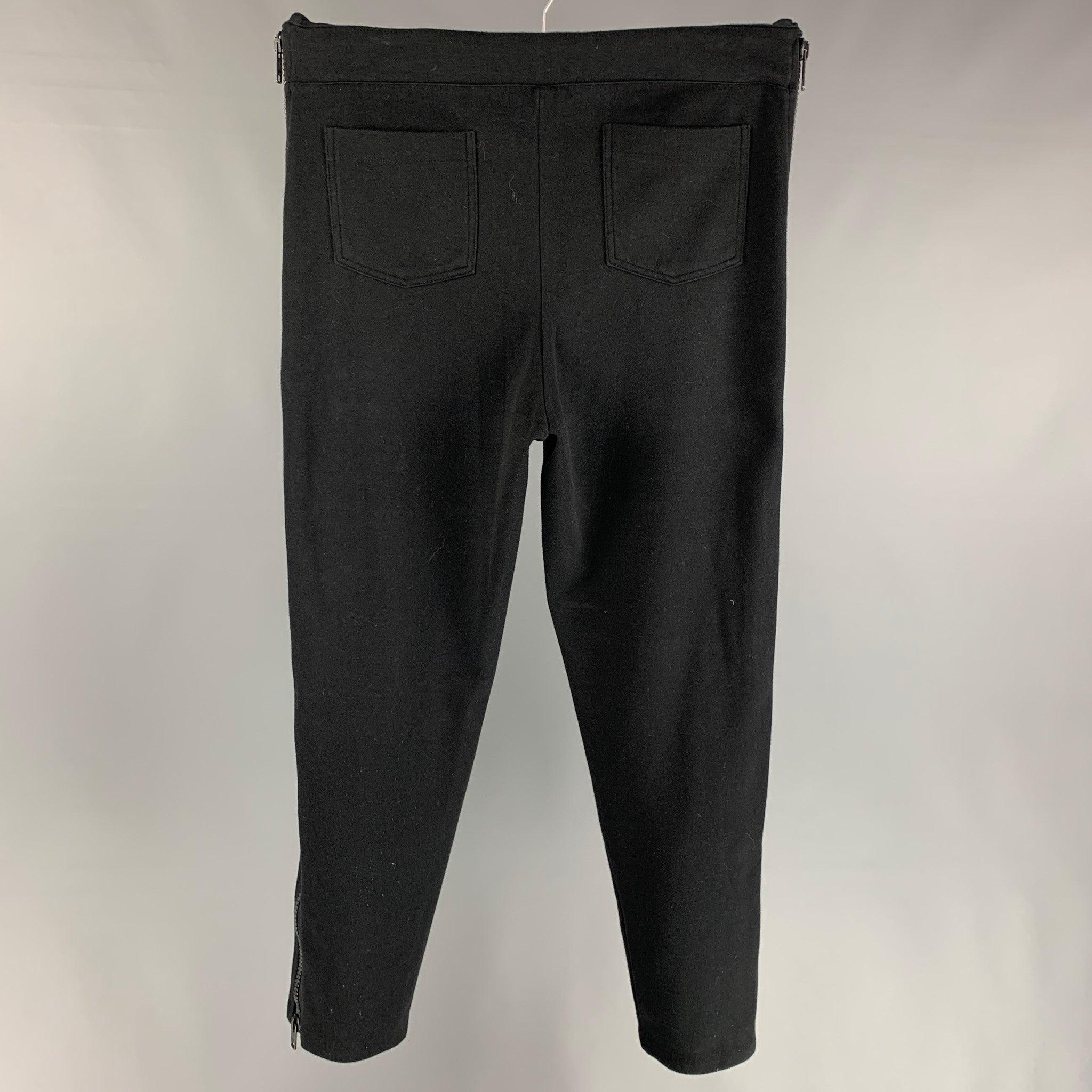 DRIES VAN NOTEN sweatpants comes in a black & white cotton / polyester featuring a slim fit, zipper details, and a drawstring.
Very Good
Pre-Owned Condition. 

Marked:   L  

Measurements: 
  Waist: 34 inches  Rise: 13 inches  Inseam: 30 inches 
  

